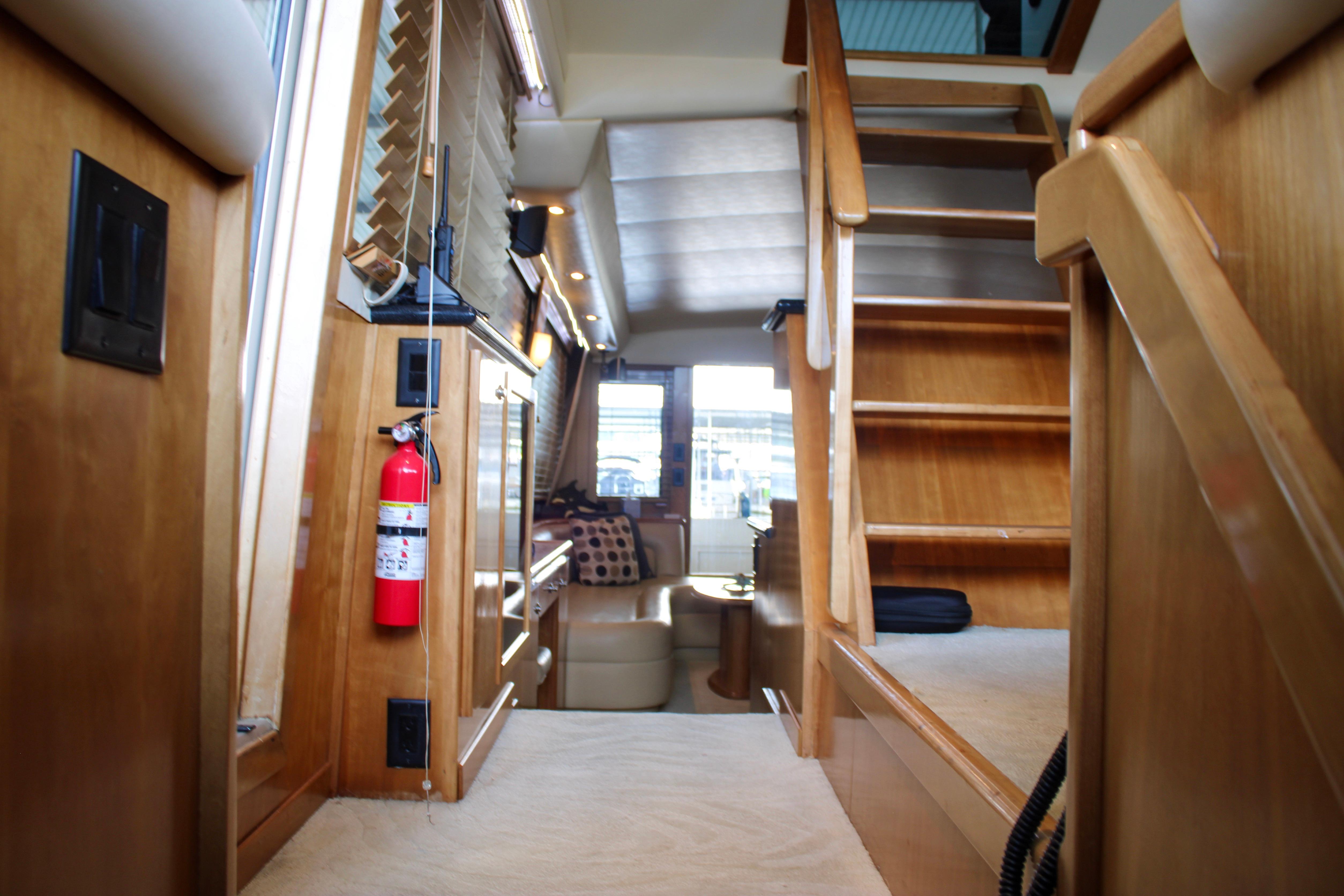 Interior of 2007 Navigator 5100 yacht with wooden stairs and modern furnishings.