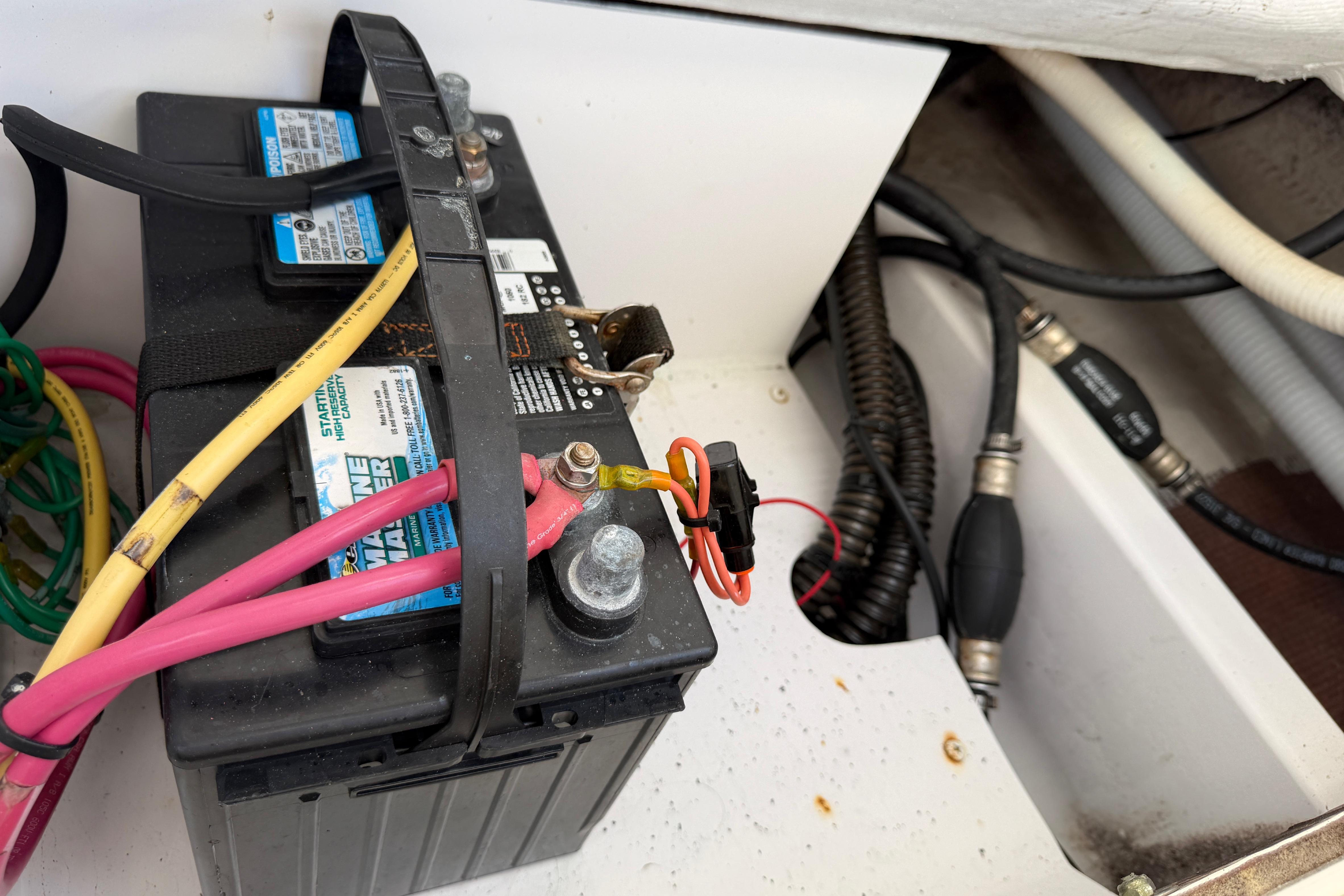 Battery setup in a 2006 Southport 26 Center Console boat, featuring cables and connectors.