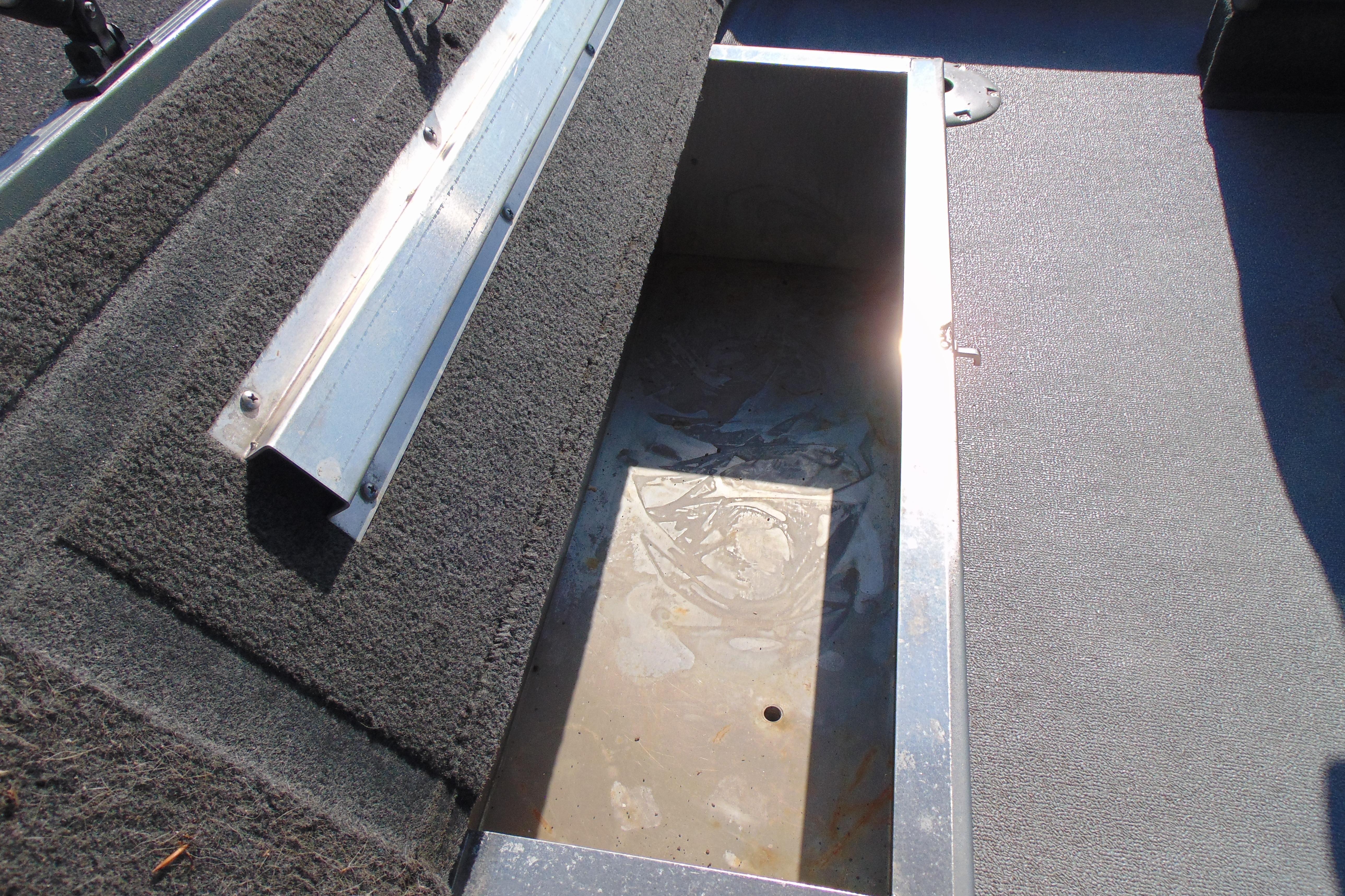 Open storage compartment in 2017 Starcraft SF 16 DLX boat, featuring carpeted interior.