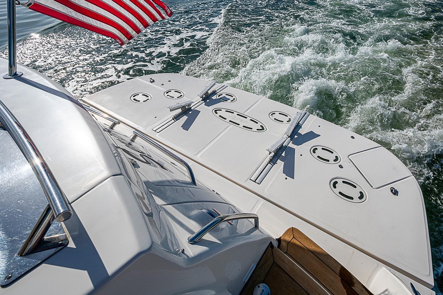 2008 Sea Ray 60 Sundancer yacht with American flag, cruising on water.