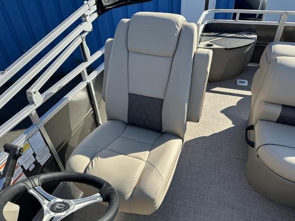 2025 Sun Tracker FB 20 DLX boat interior with beige seating and steering wheel.
