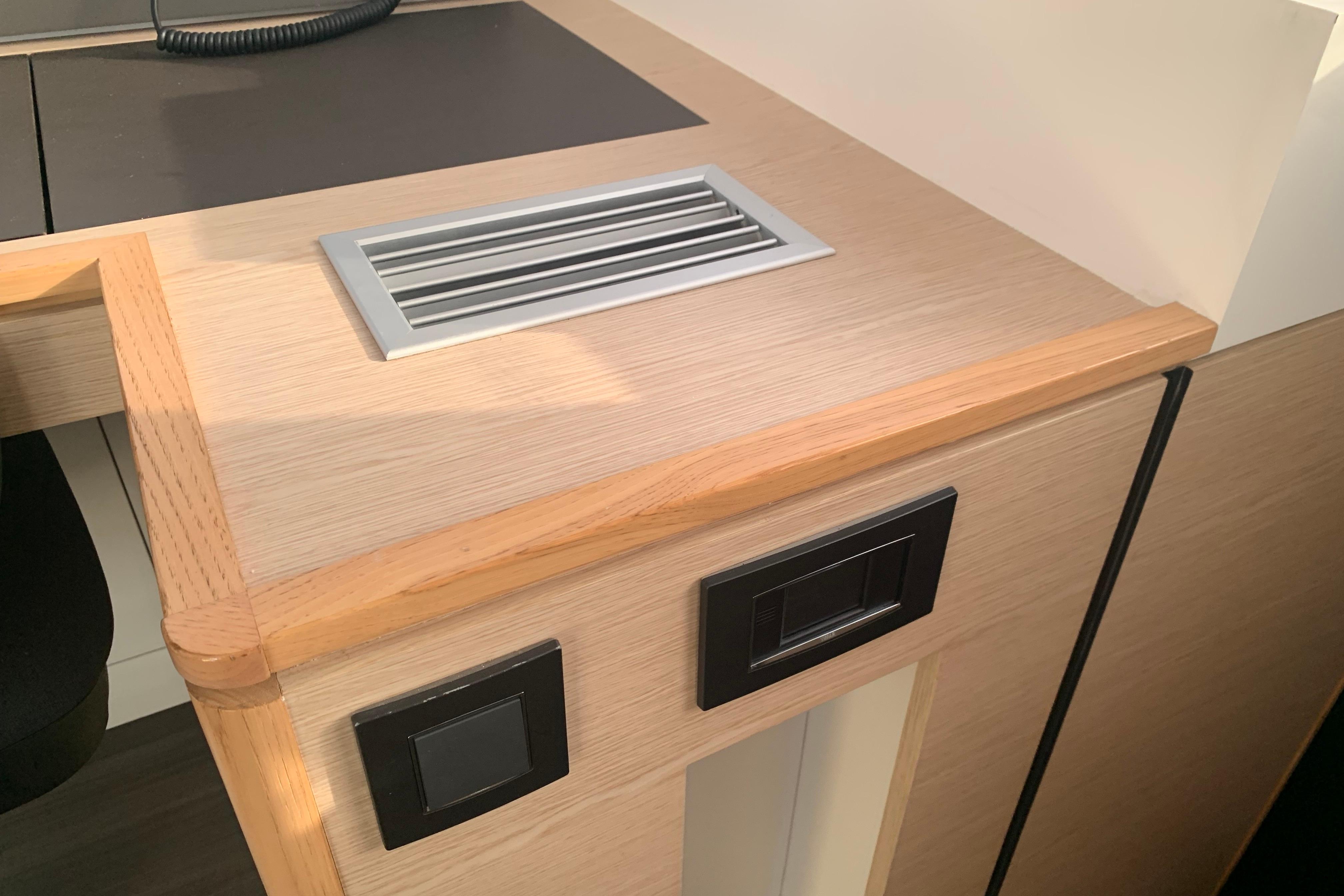 Modern interior detail of 2024 Outremer 45 yacht with sleek wood finish.