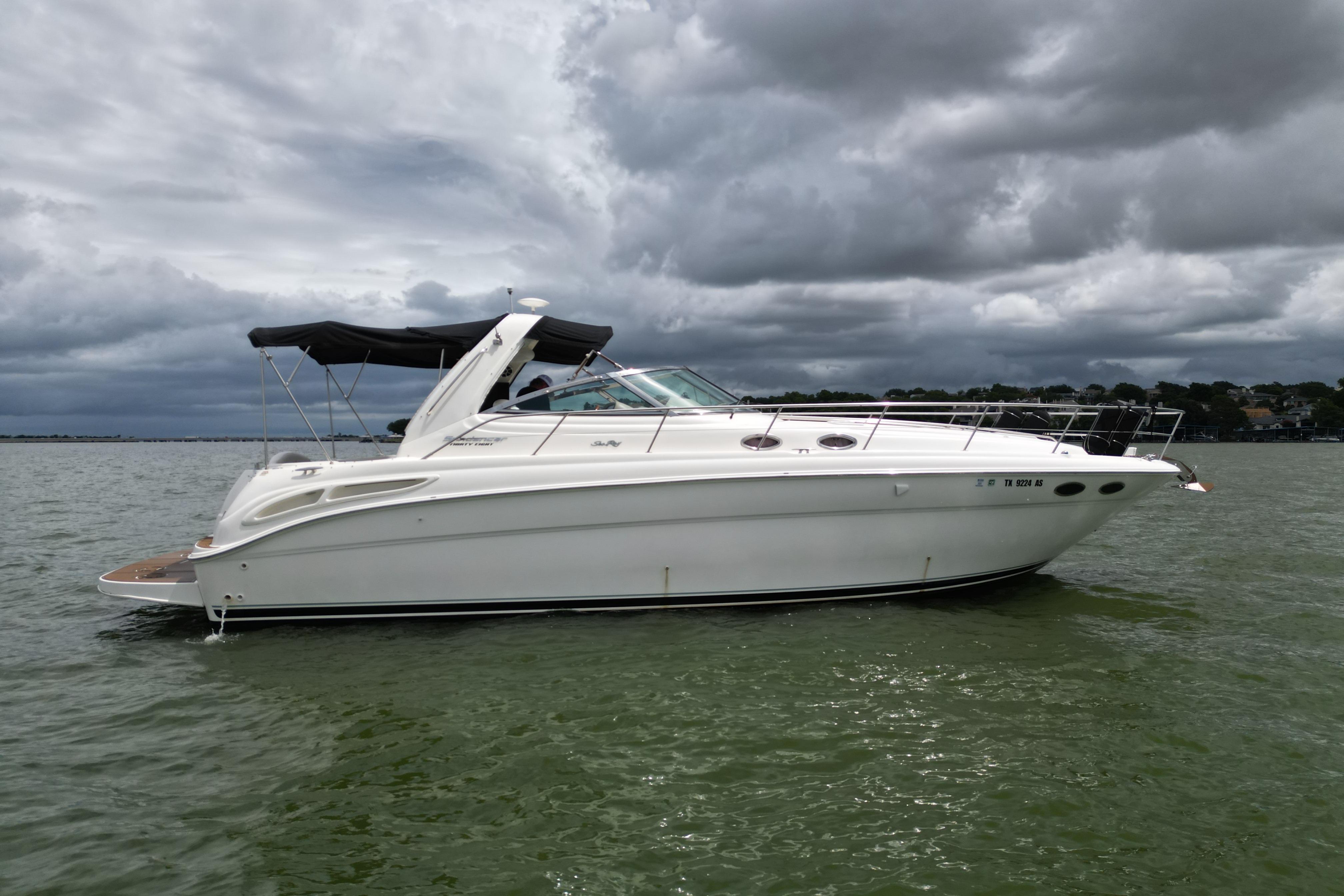 2001 Sea Ray 380 Sundancer yacht on a cloudy day, anchored in calm waters.
