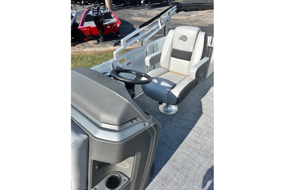 2026 Sun Tracker Party Barge 18 DLX pontoon boat interior with captain's chair and steering console.