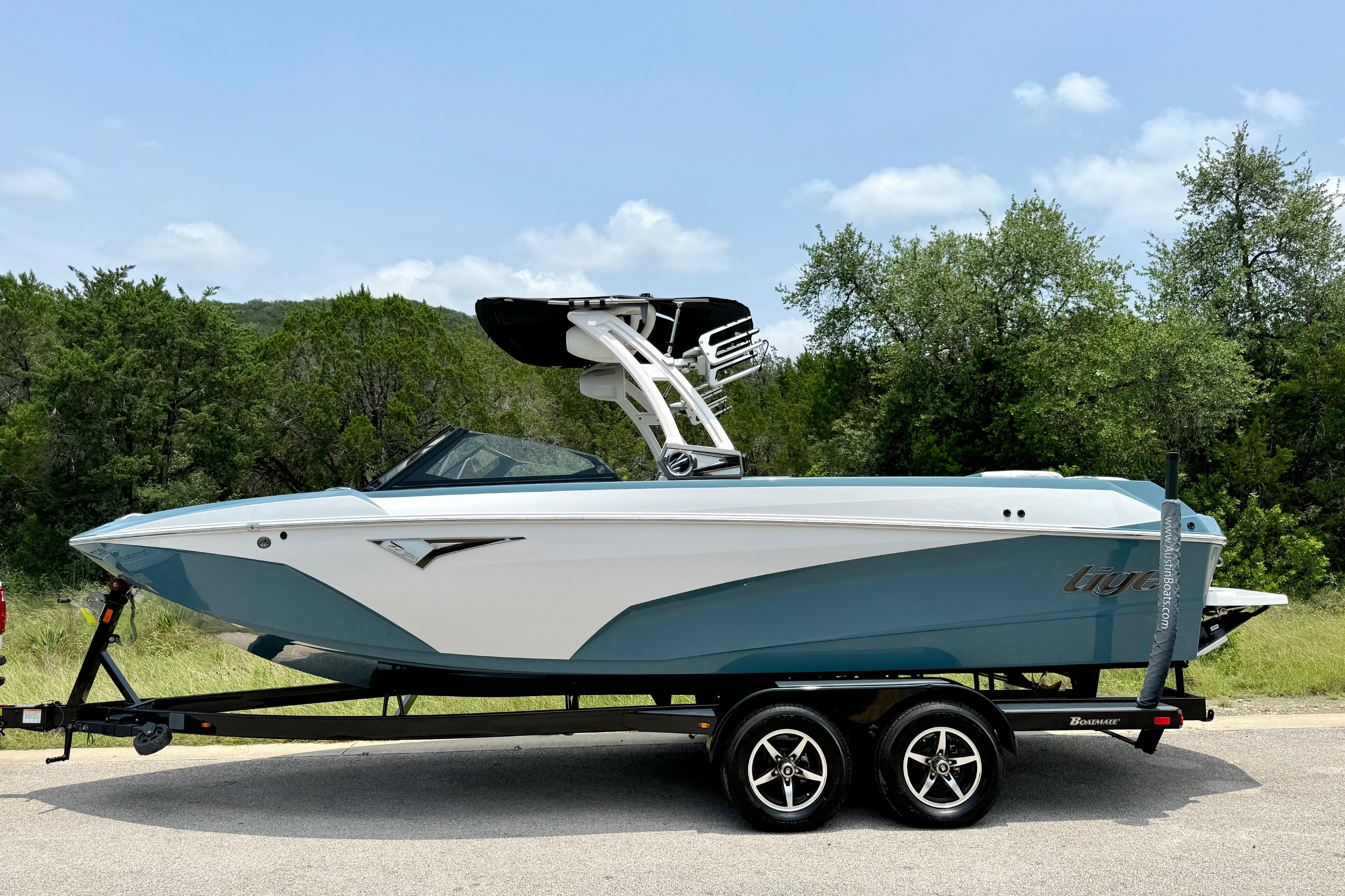 2021 Tige Z3 boat on trailer, parked outdoors with trees in background.