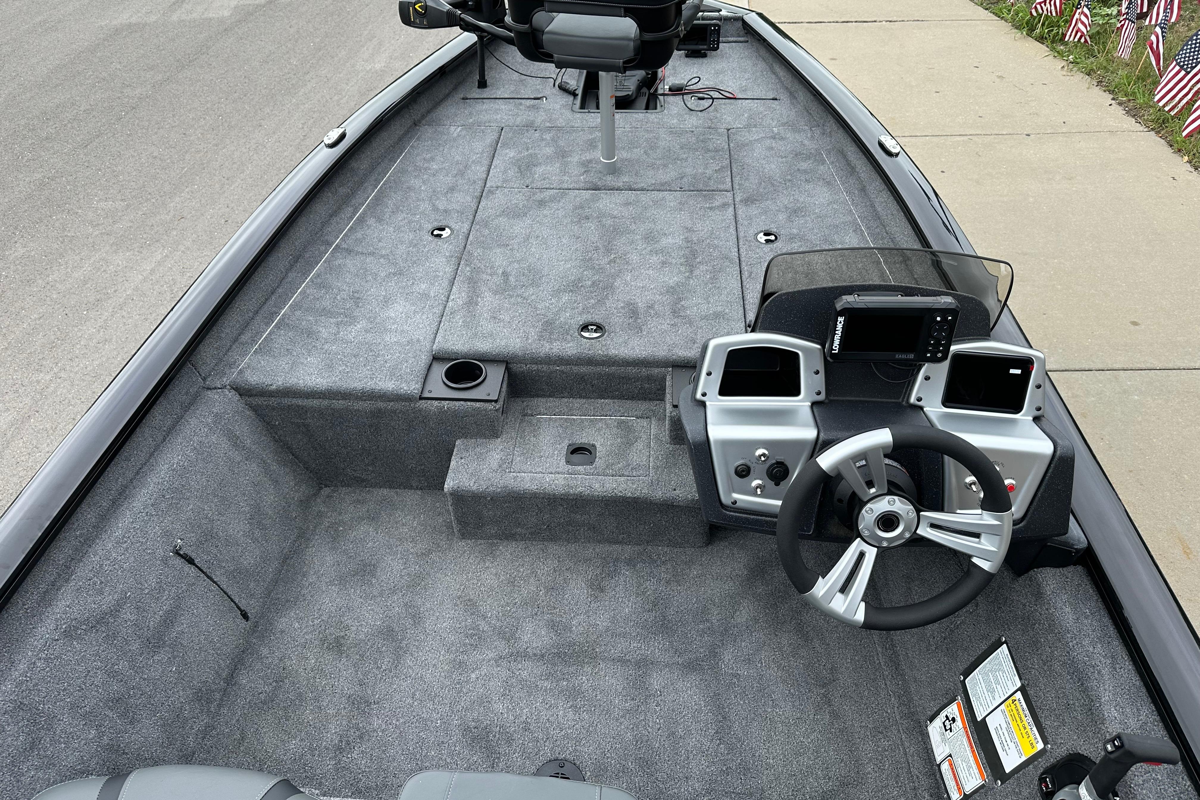 2026 Tracker Pro Team 190 boat interior with steering console and carpeted deck.