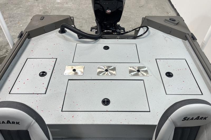2026 SeaArk Flex 19 Pro boat deck with storage compartments and motor.