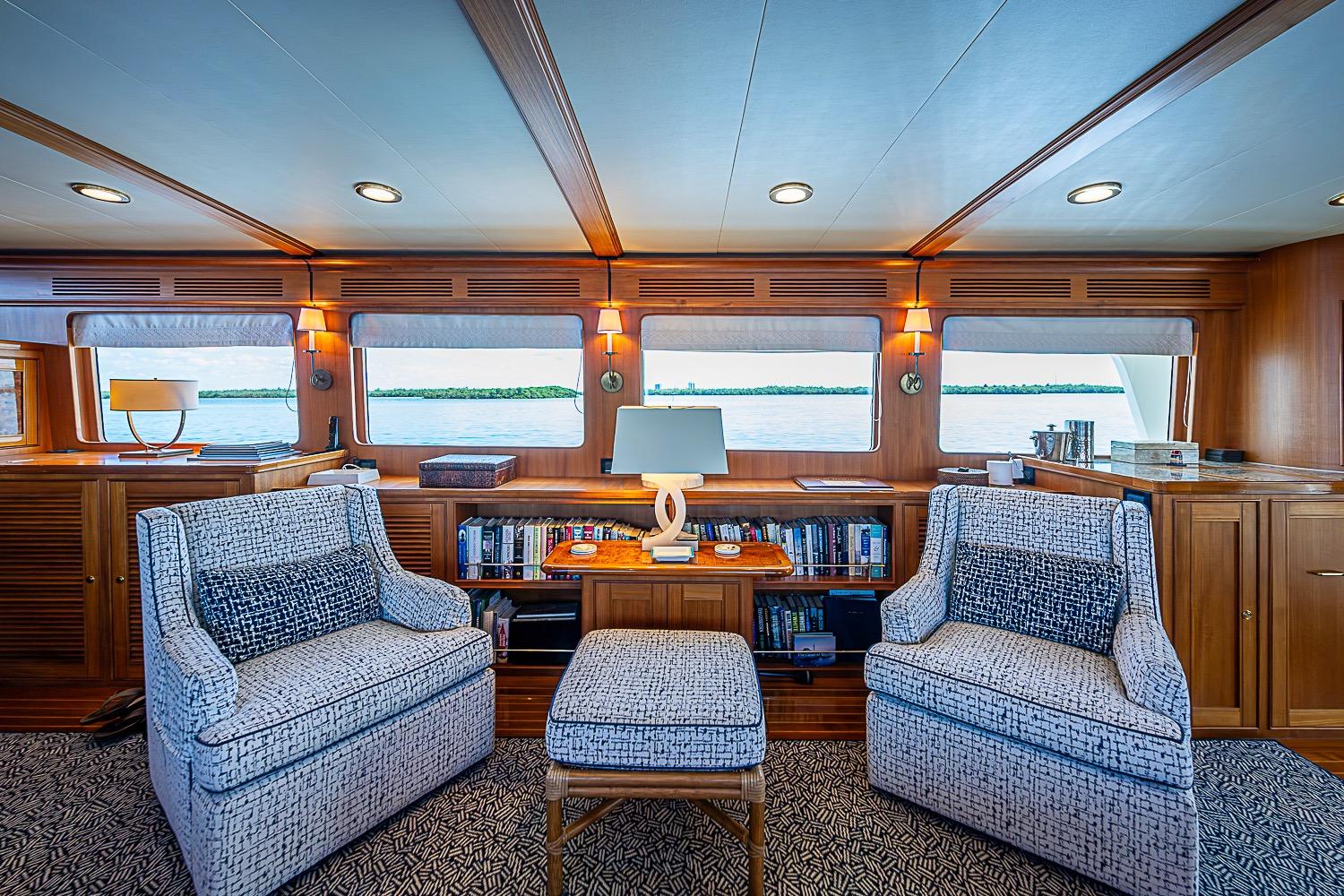 Luxurious interior of 2014 Marlow 80 Explorer yacht with elegant seating and ocean view.