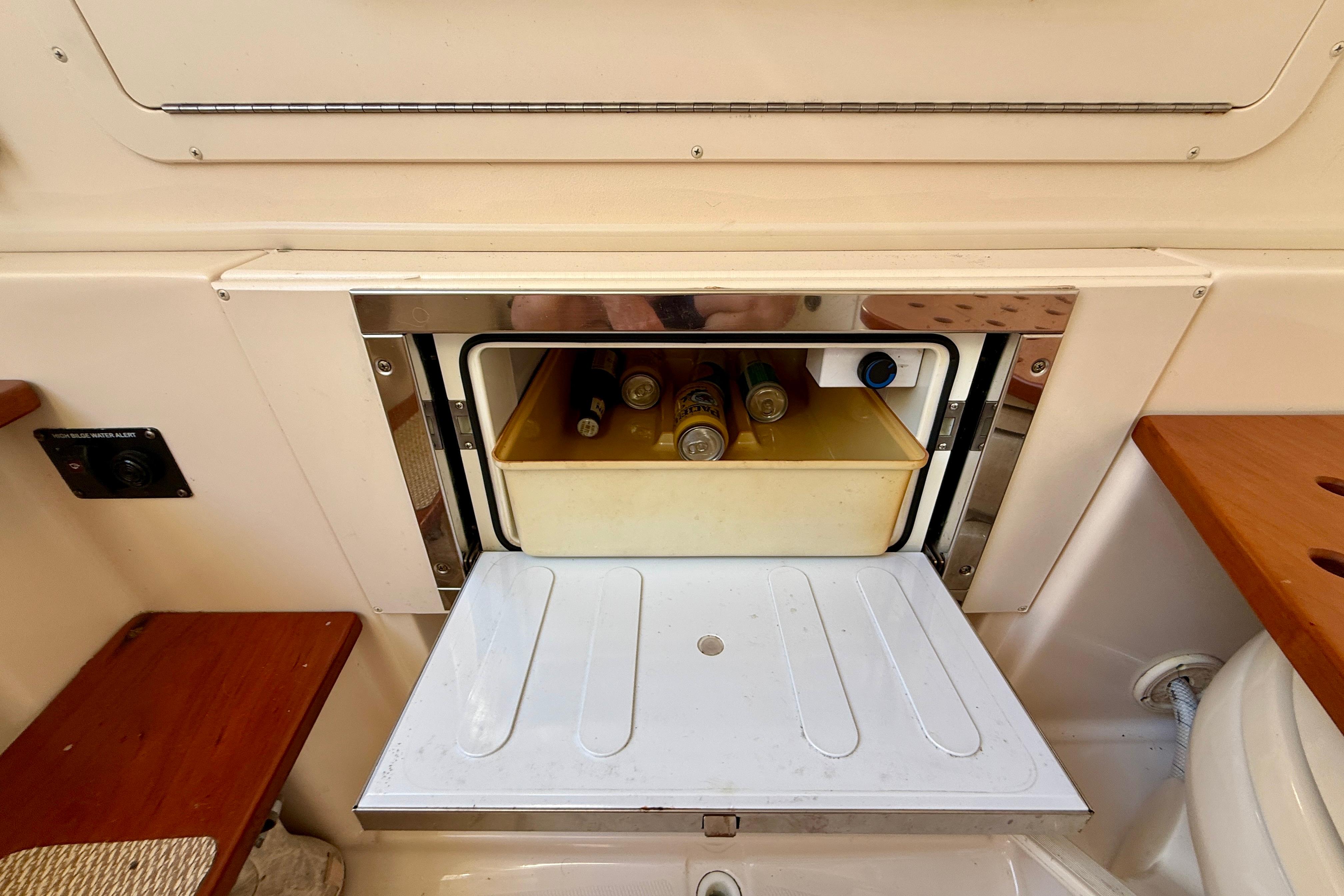 Built-in cooler with drinks on a 2012 Grady-White Canyon 336 boat.