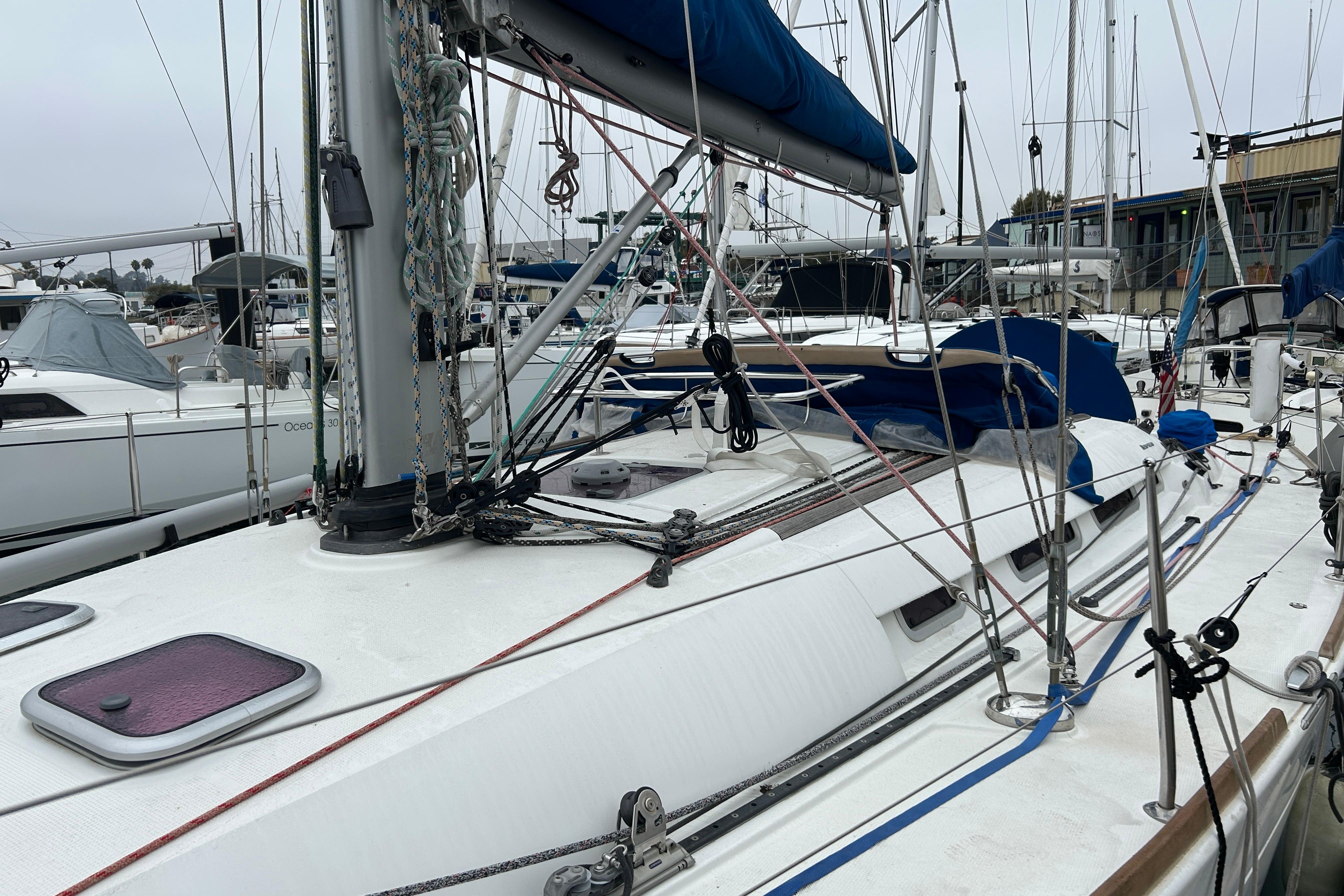 2012 Beneteau First 40 sailboat docked in marina, featuring rigging and deck details.