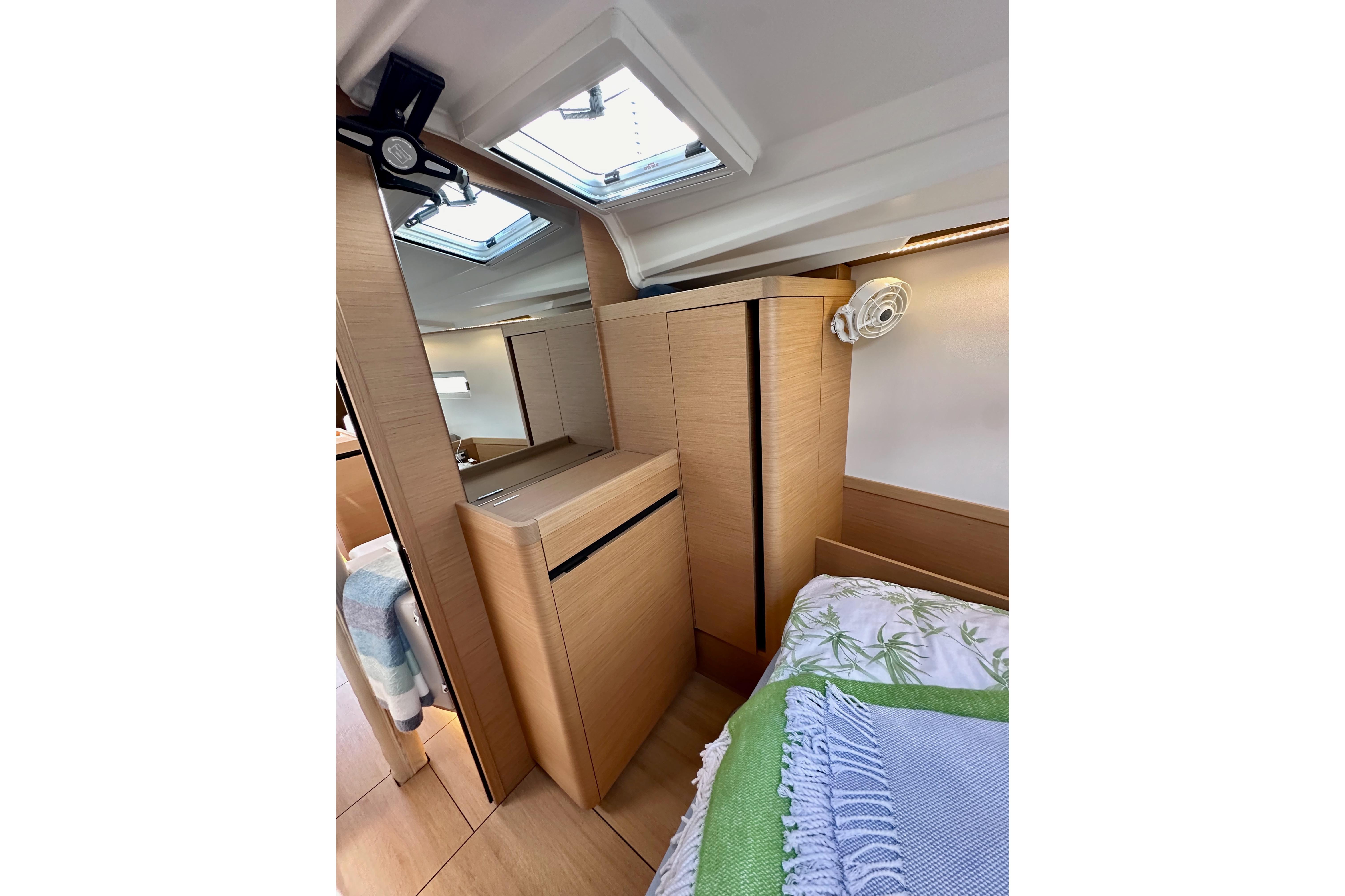 2024 Jeanneau Sun Odyssey 410 interior cabin with wooden cabinetry and skylight.