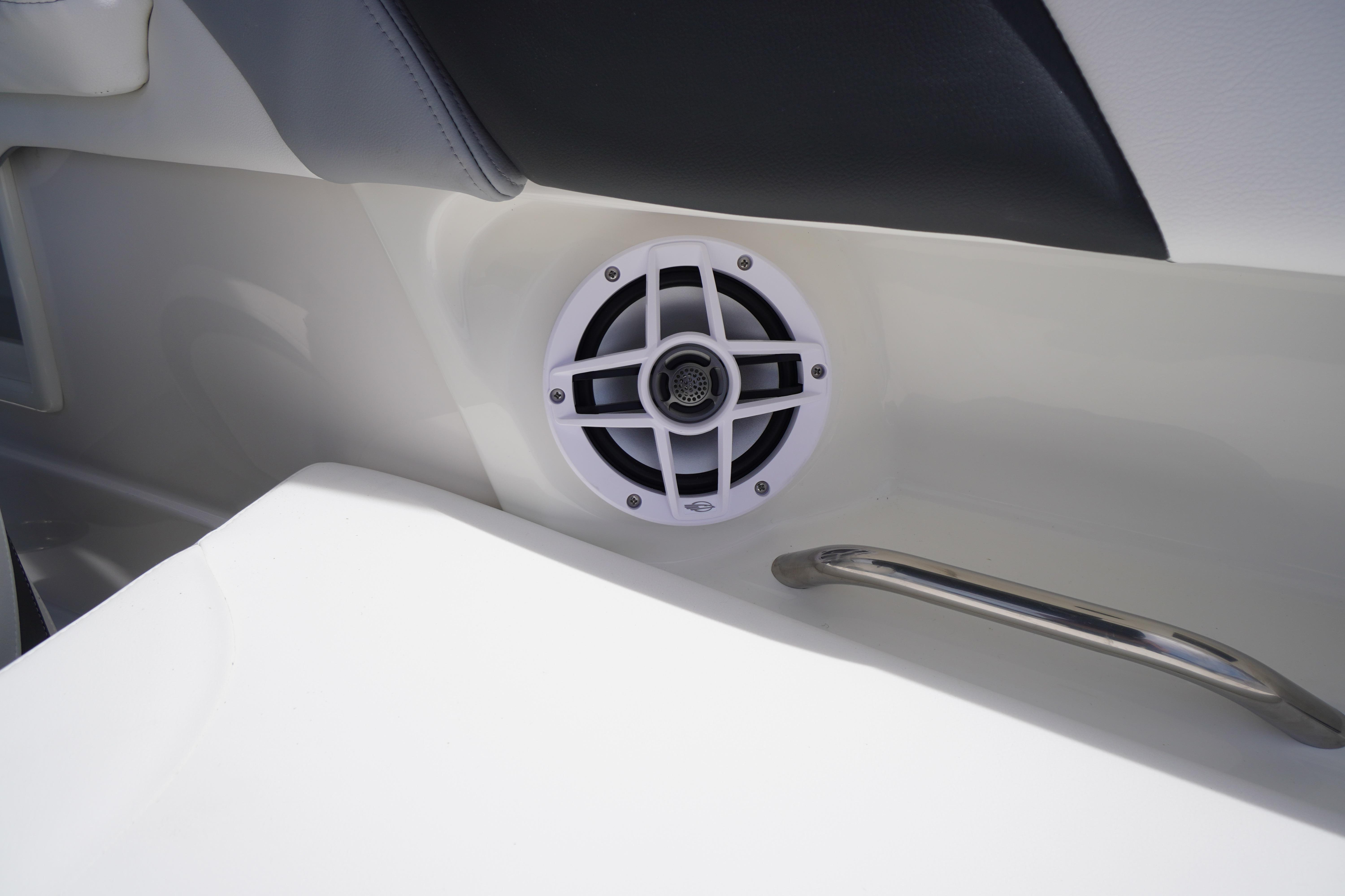 2026 Chaparral 23 SSi OB boat interior with speaker and handle detail.