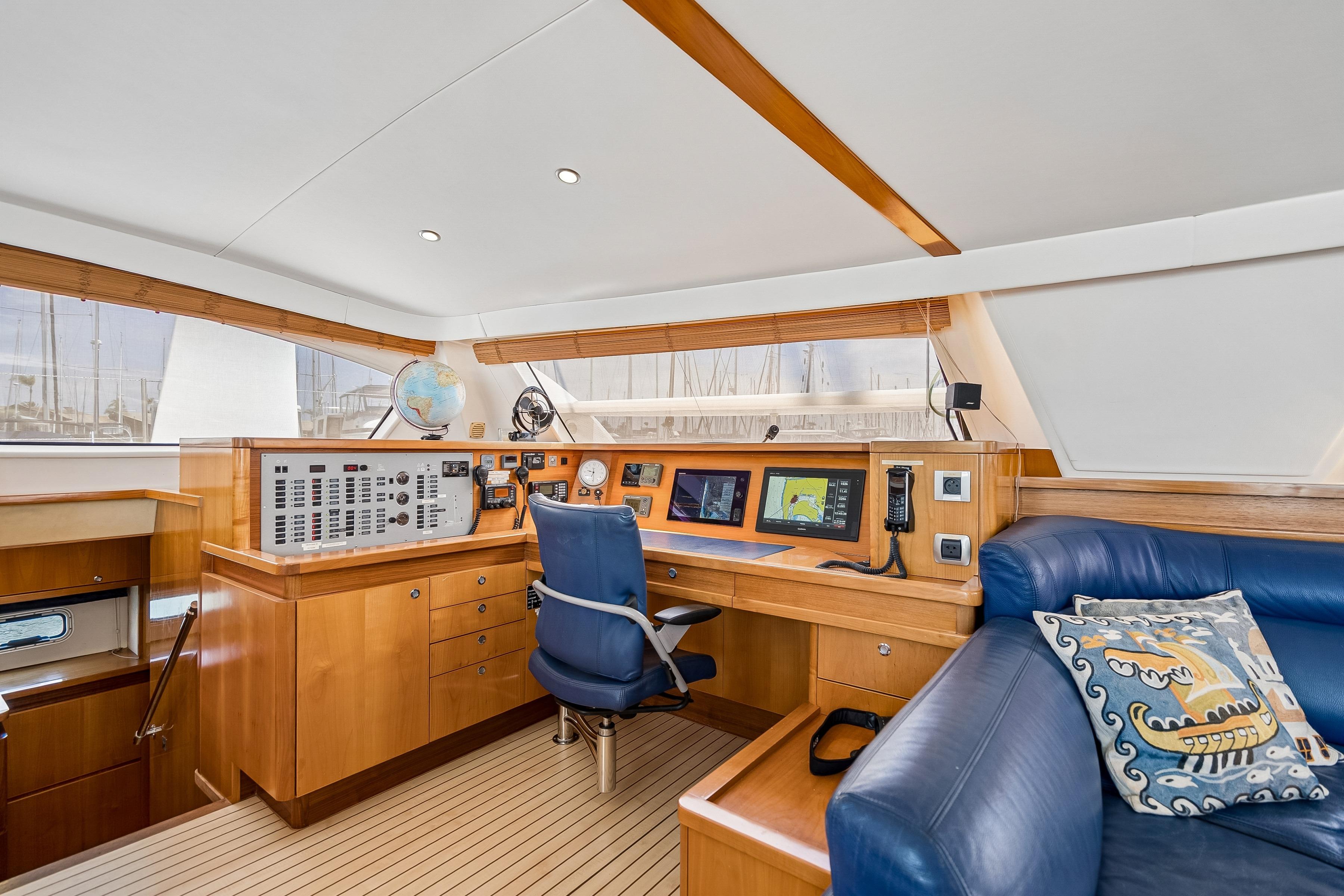 Luxurious 2009 Catana 65 yacht interior with navigation station and plush seating.