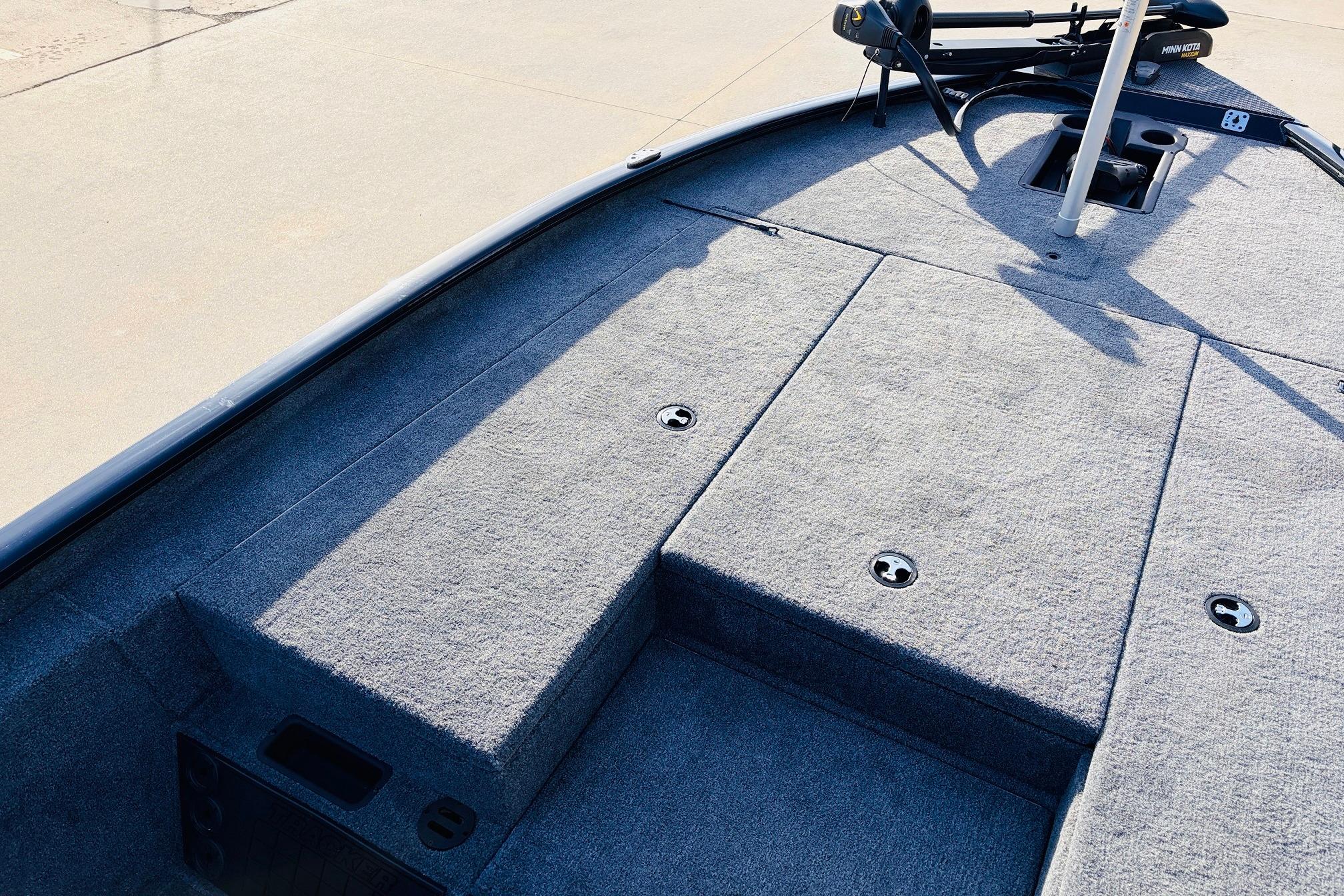 2025 Tracker Savage 215 boat deck with carpeted surface and storage compartments.