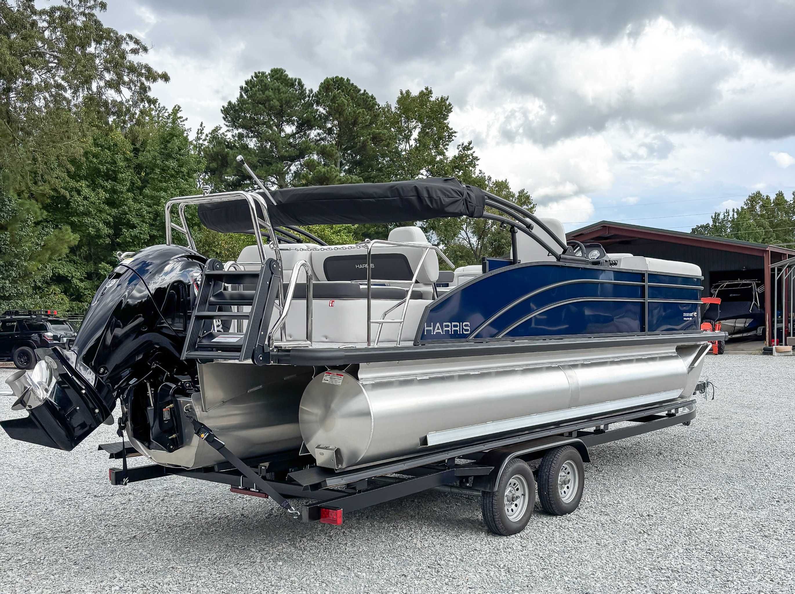 2026 Harris Cruiser 230 SLDH pontoon boat on trailer outdoors.