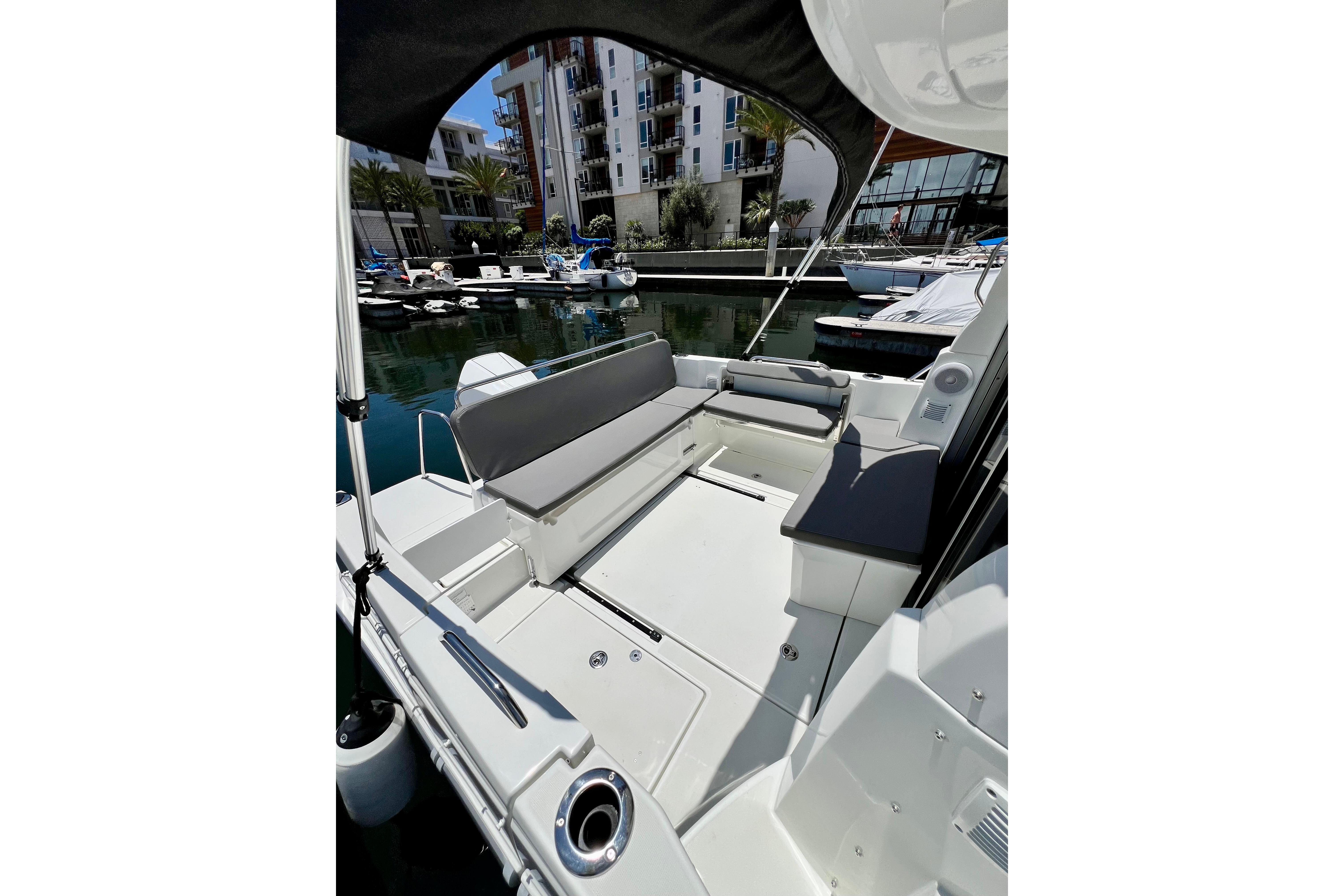 2023 Beneteau Antares 8 boat interior with seating, docked in a marina.