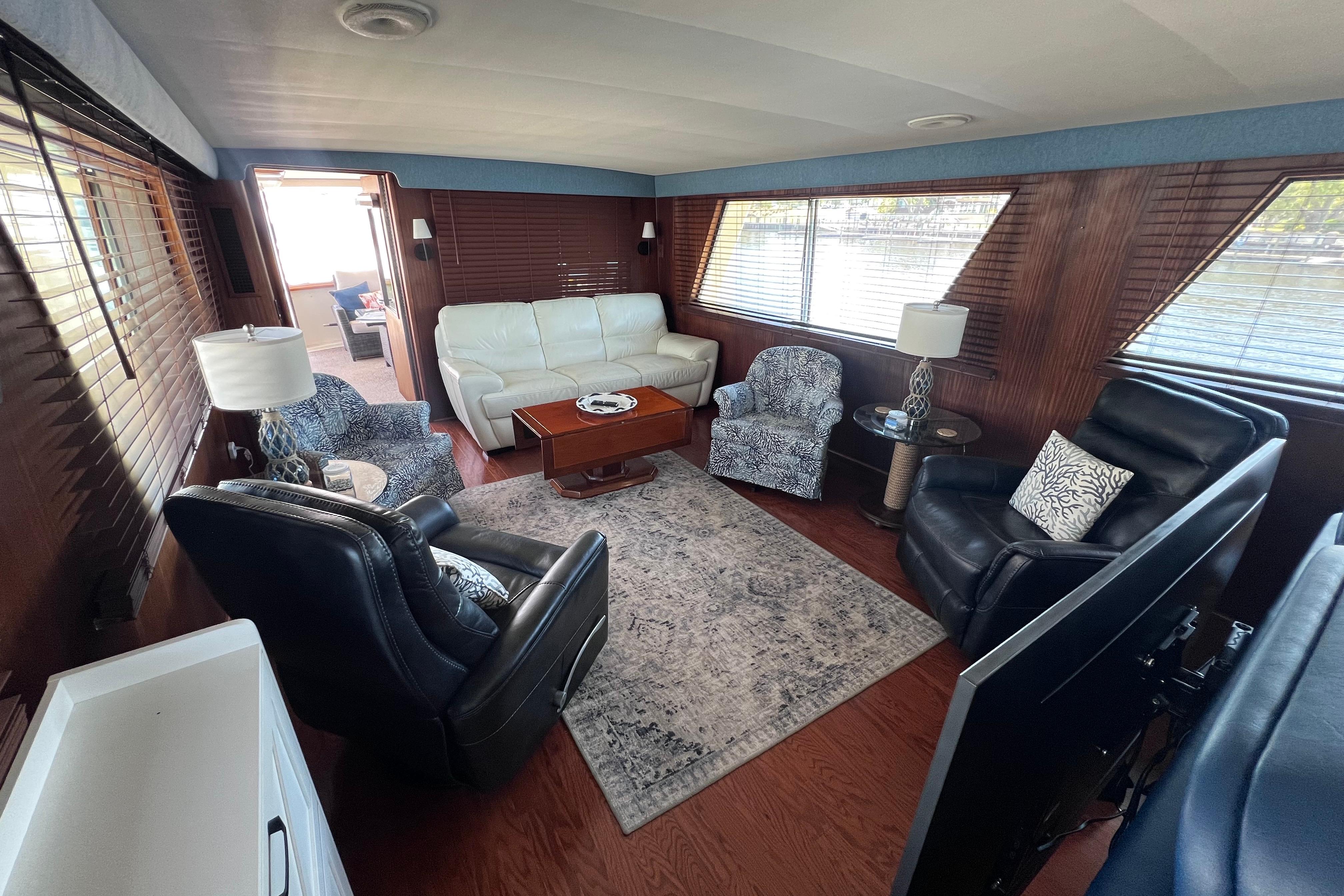 Luxurious interior of 1987 Hatteras 70 Cockpit Motor Yacht with elegant seating and decor.