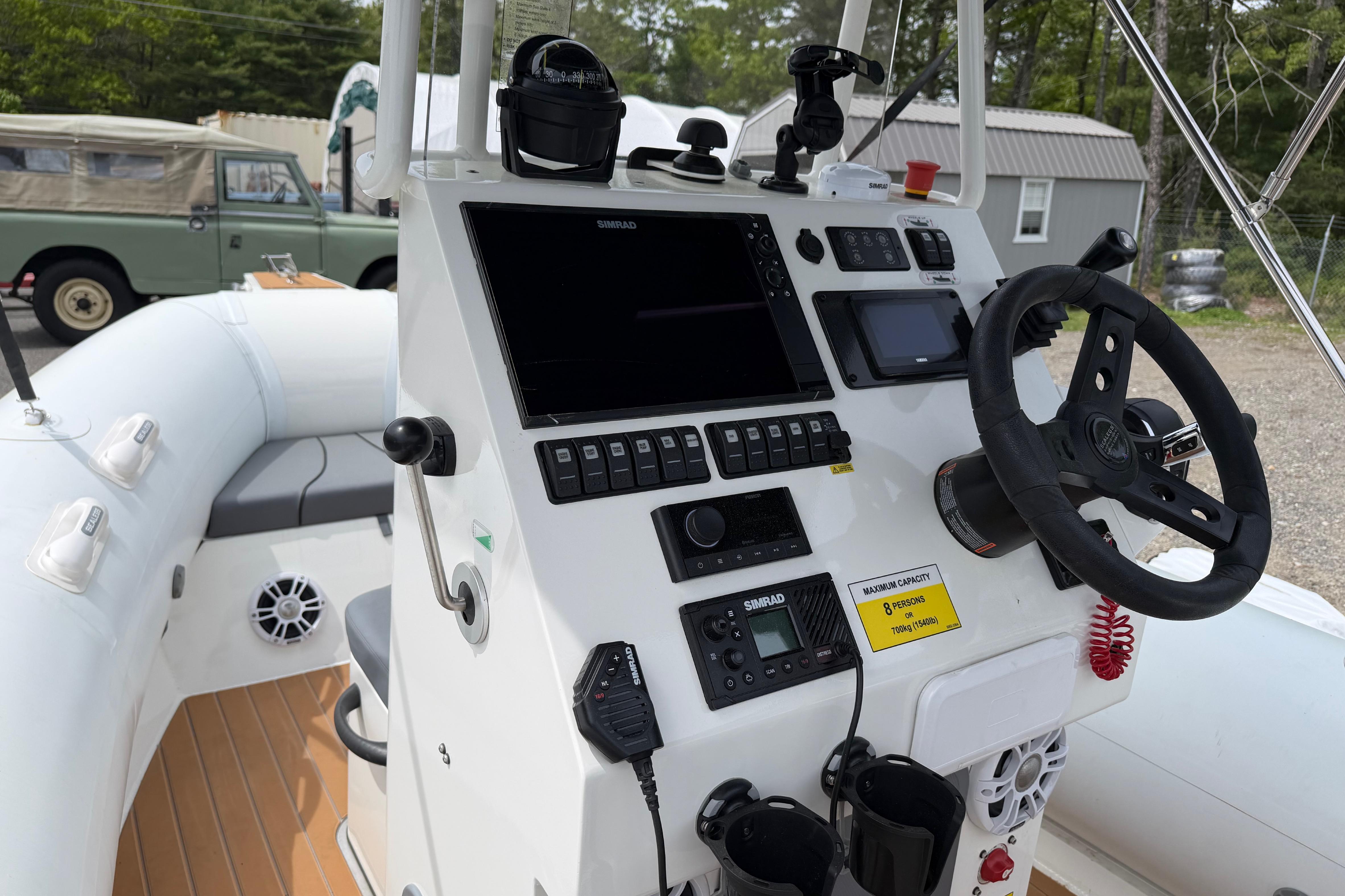 2024 Sealegs 7.1m RIB boat dashboard with steering wheel and navigation controls.