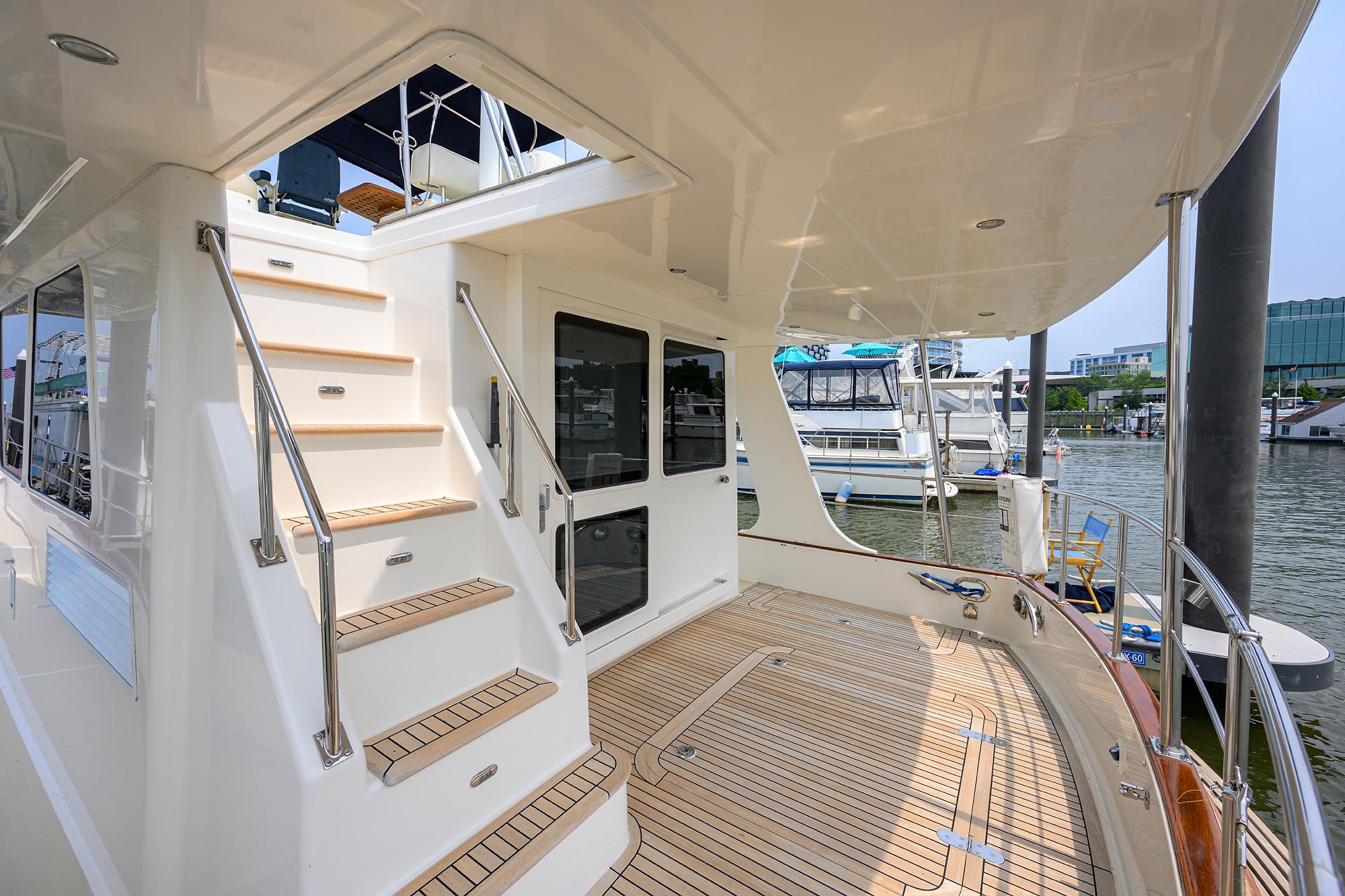 2011 Grand Banks 41 Europa yacht deck with stairs and marina view.