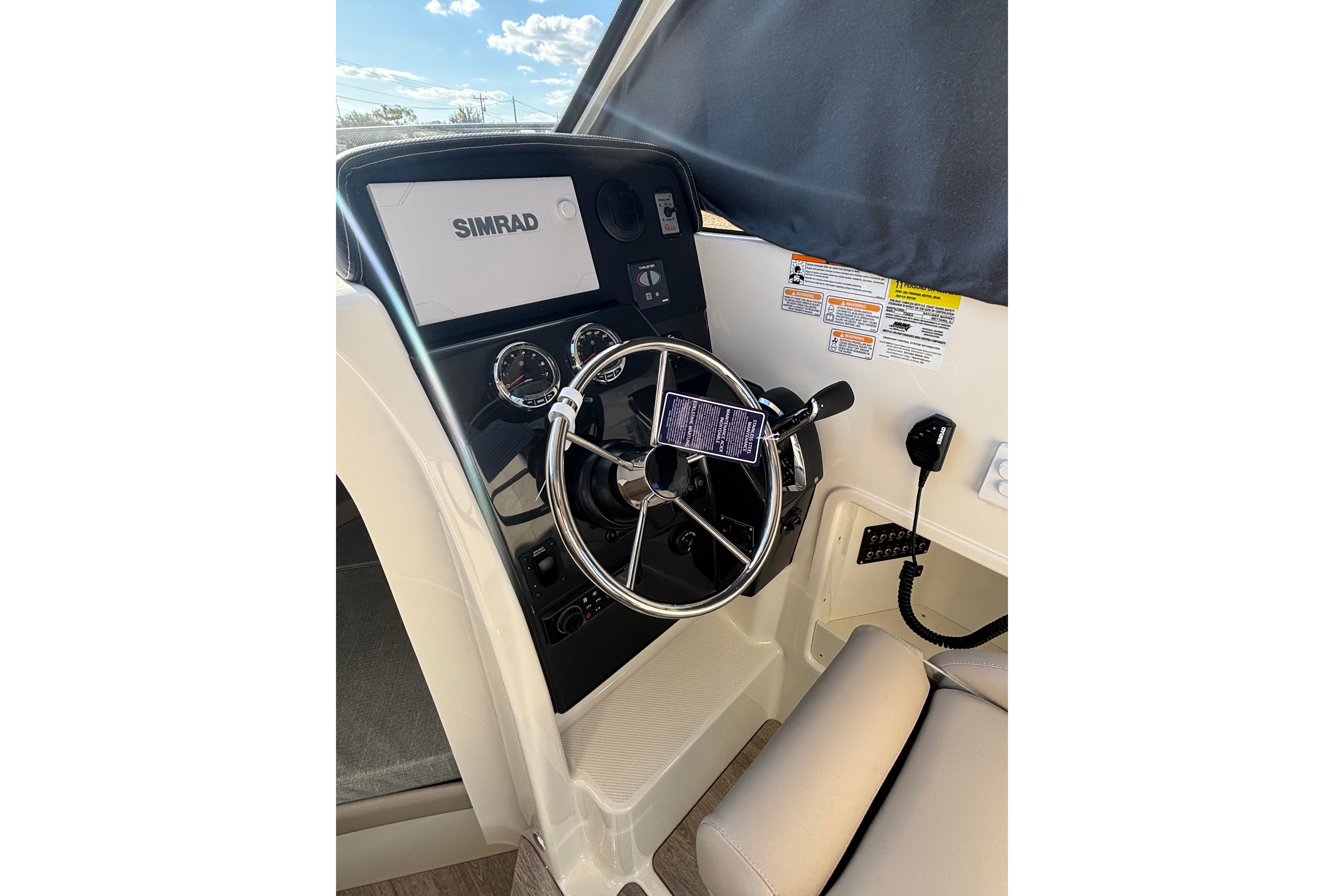 2026 Trophy T 25 Explorer boat dashboard with steering wheel and Simrad display.