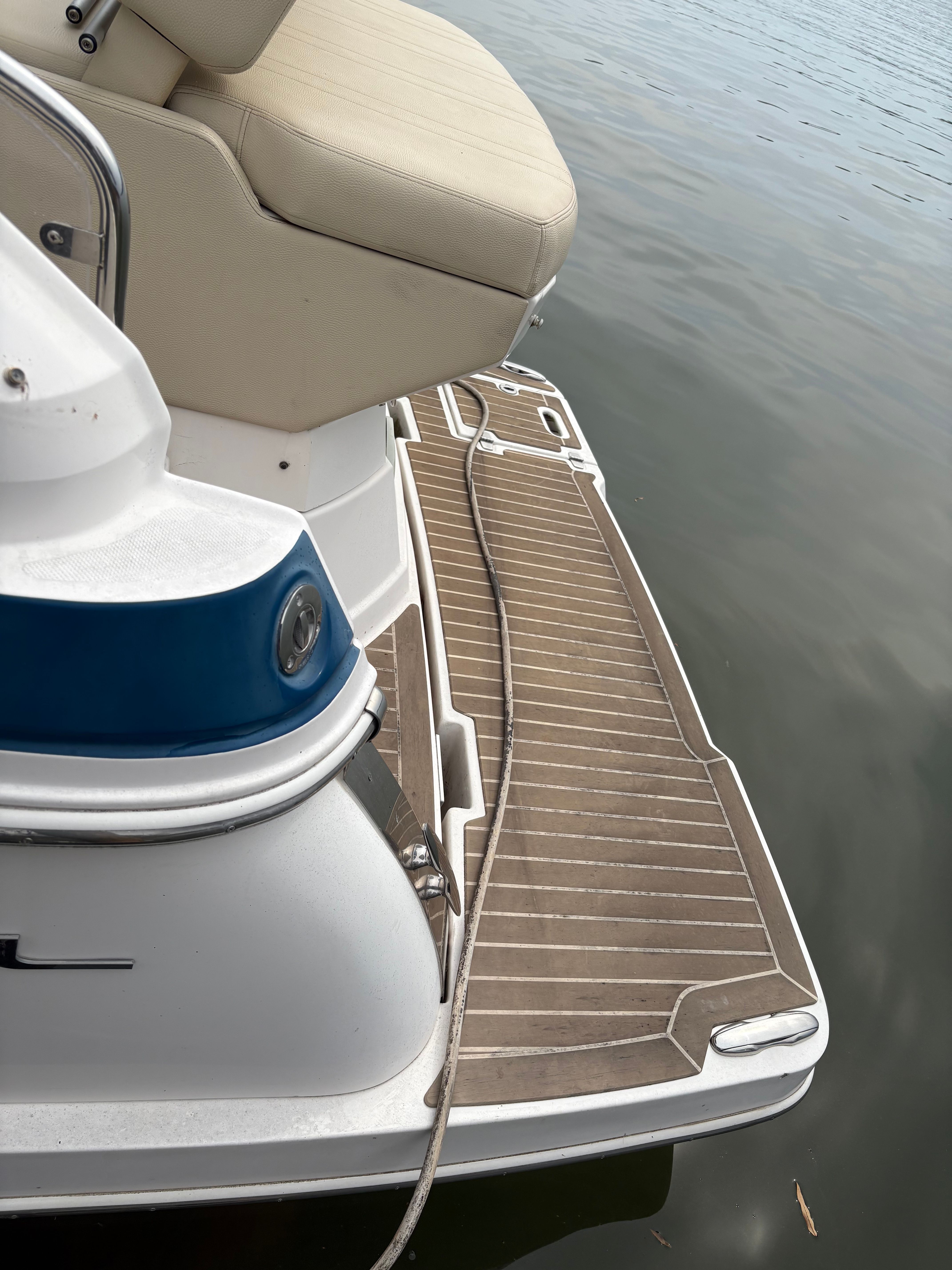 2019 Regal 28 Express boat with seat and swim platform.