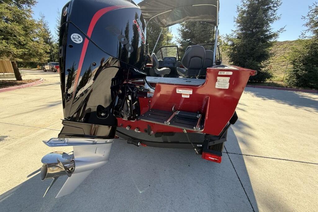 2024 Tracker Targa V-19 WT boat with powerful outboard motor, parked outdoors.