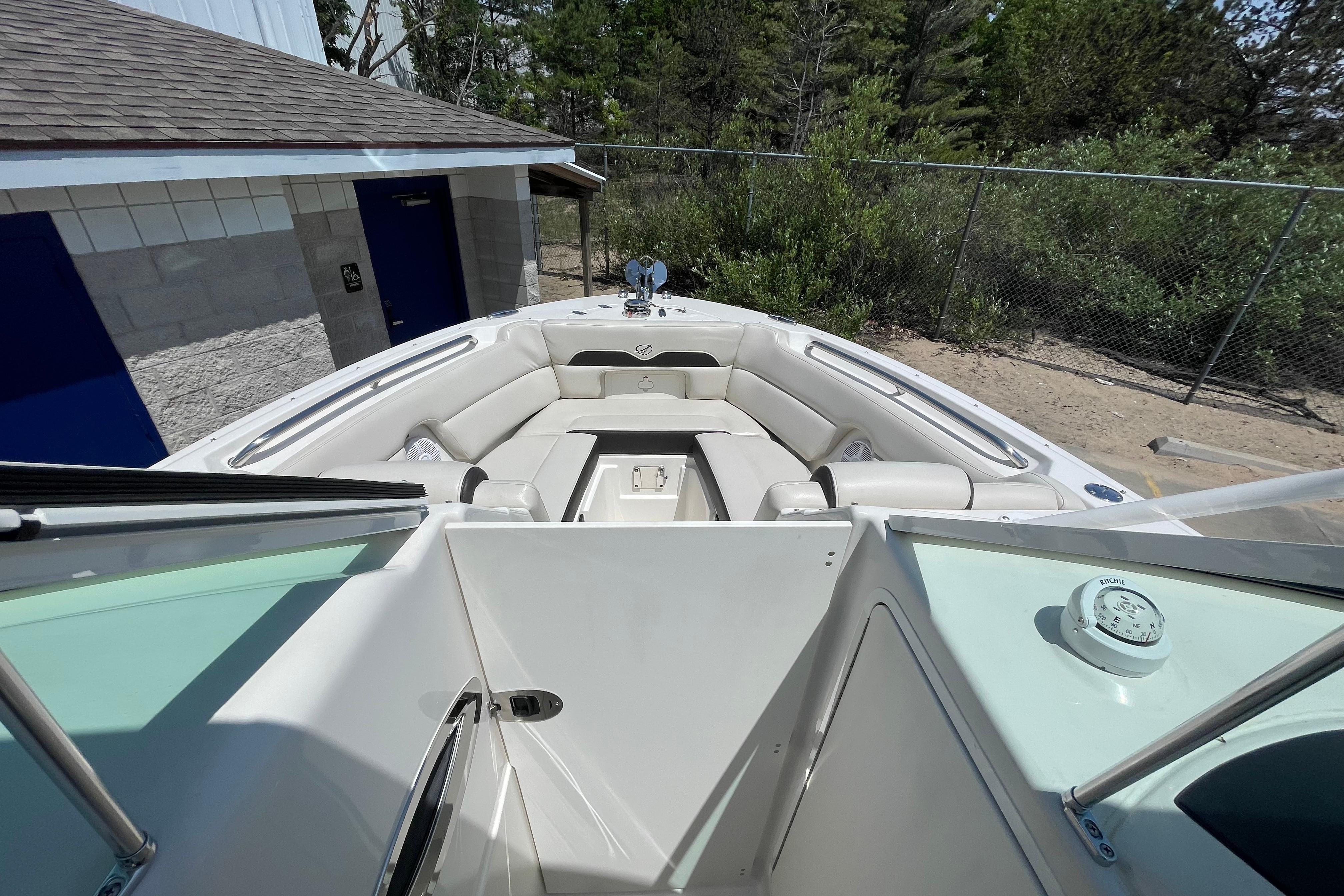 2022 Sailfish 245 DC boat interior with cushioned seating and open deck view.