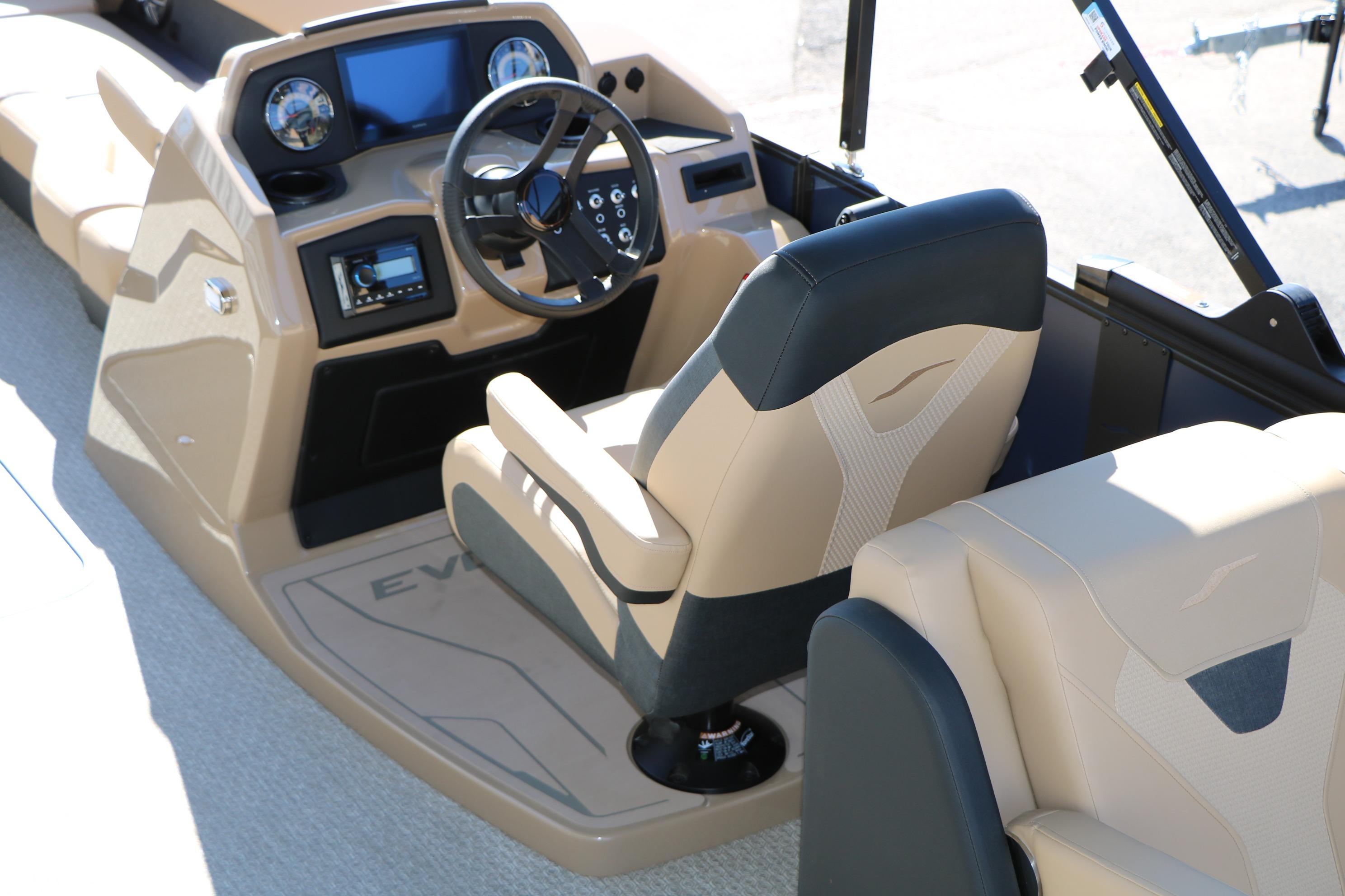 2026 Evotti 525 QL Tri-Toon boat interior with steering console and seating.