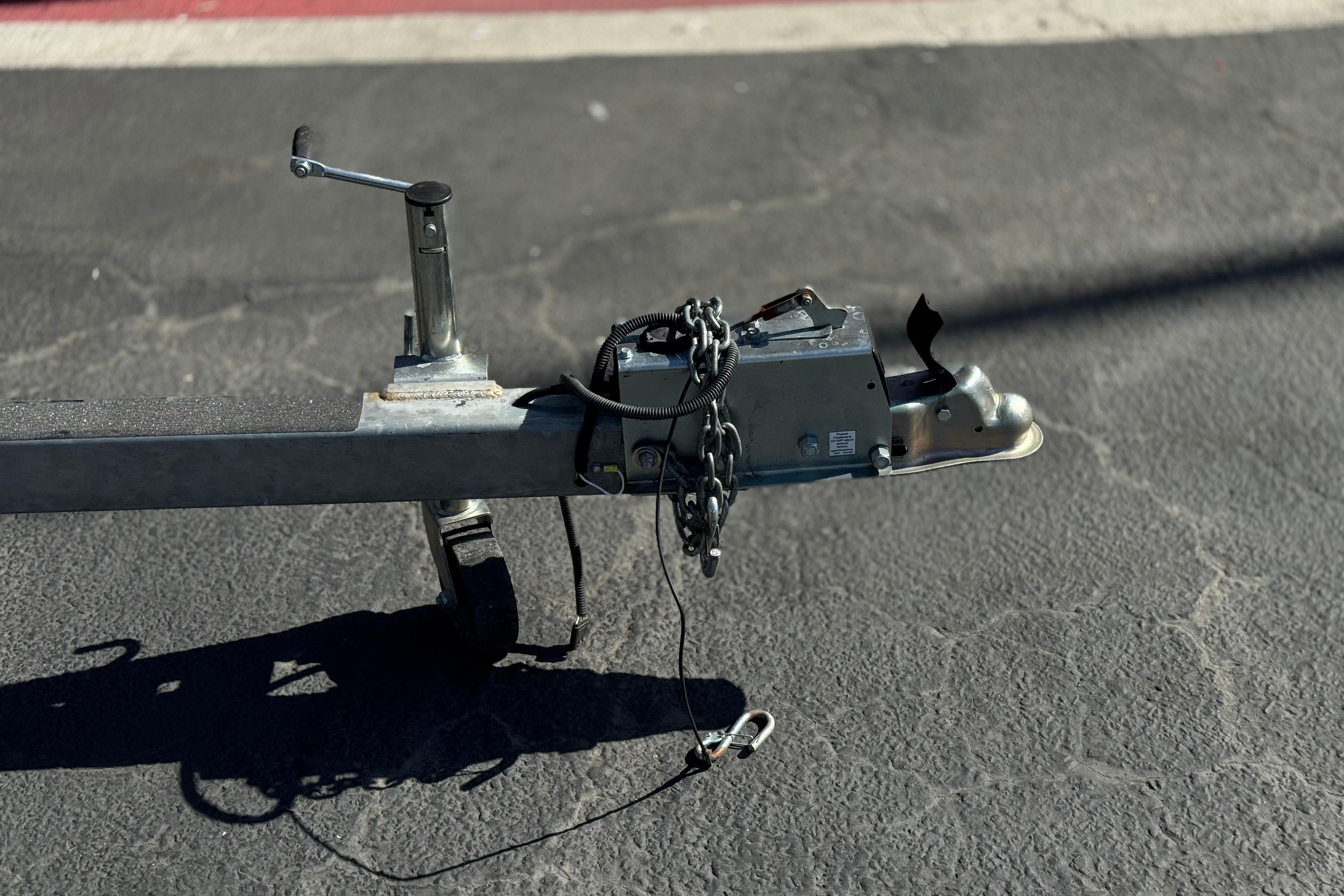 Trailer hitch of a 2023 Lexington 623 ST Xtreme on asphalt pavement.