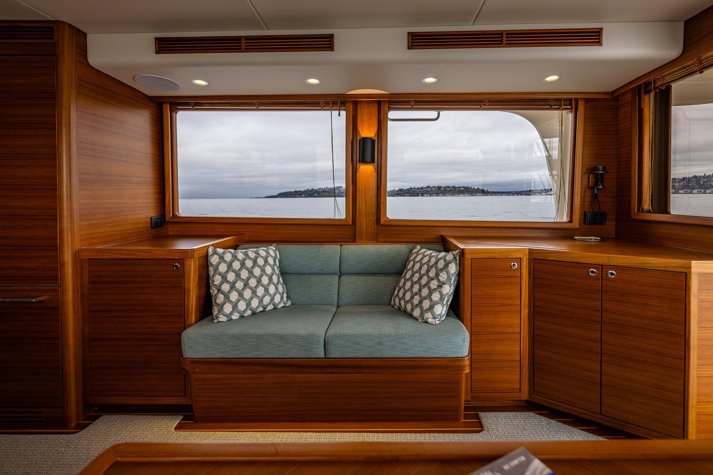 Luxurious interior of 2026 Fleming 55 Pilothouse yacht with scenic ocean view.