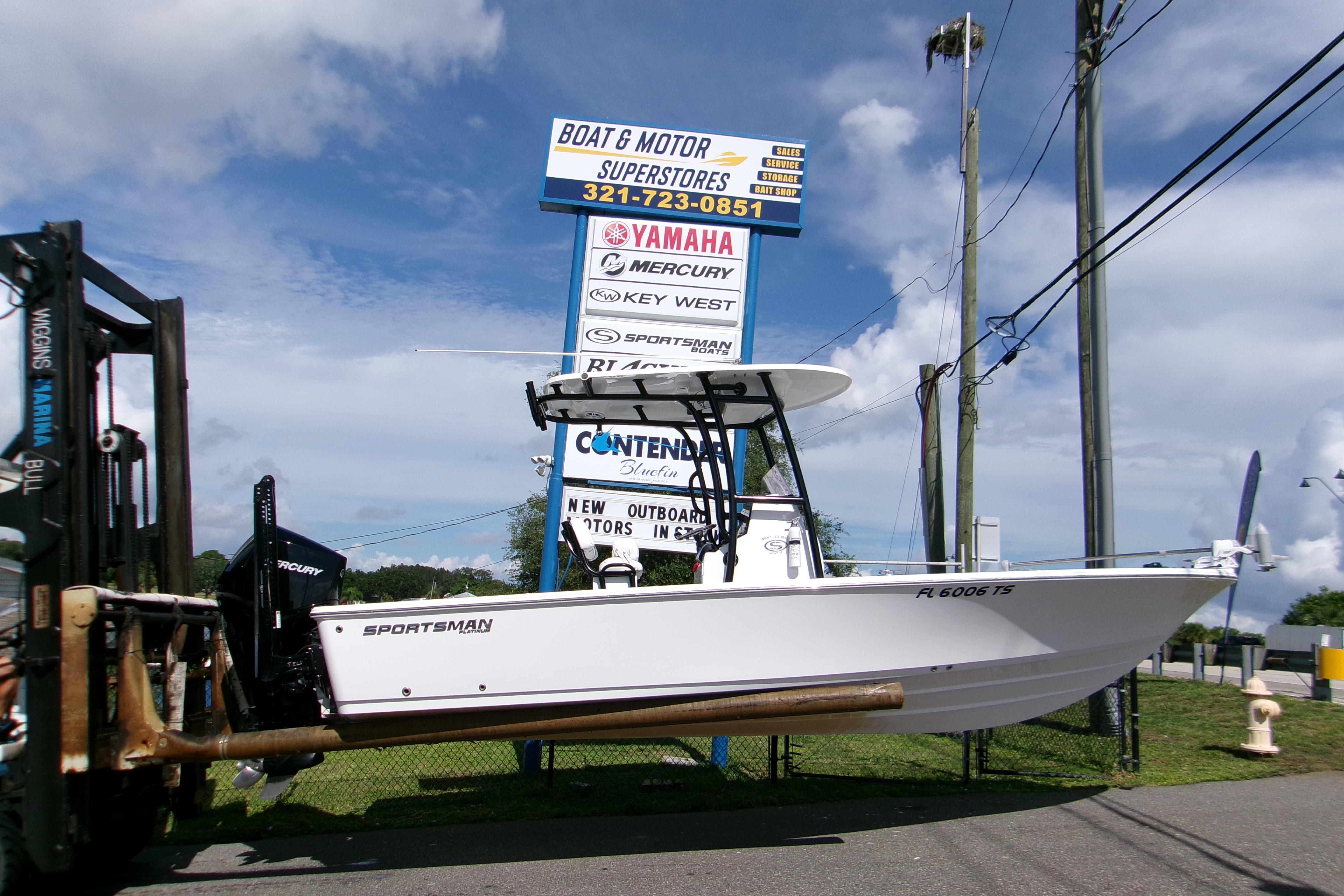2024 Sportsman Masters 227 Bay Boat displayed at a dealership, ready for sale.