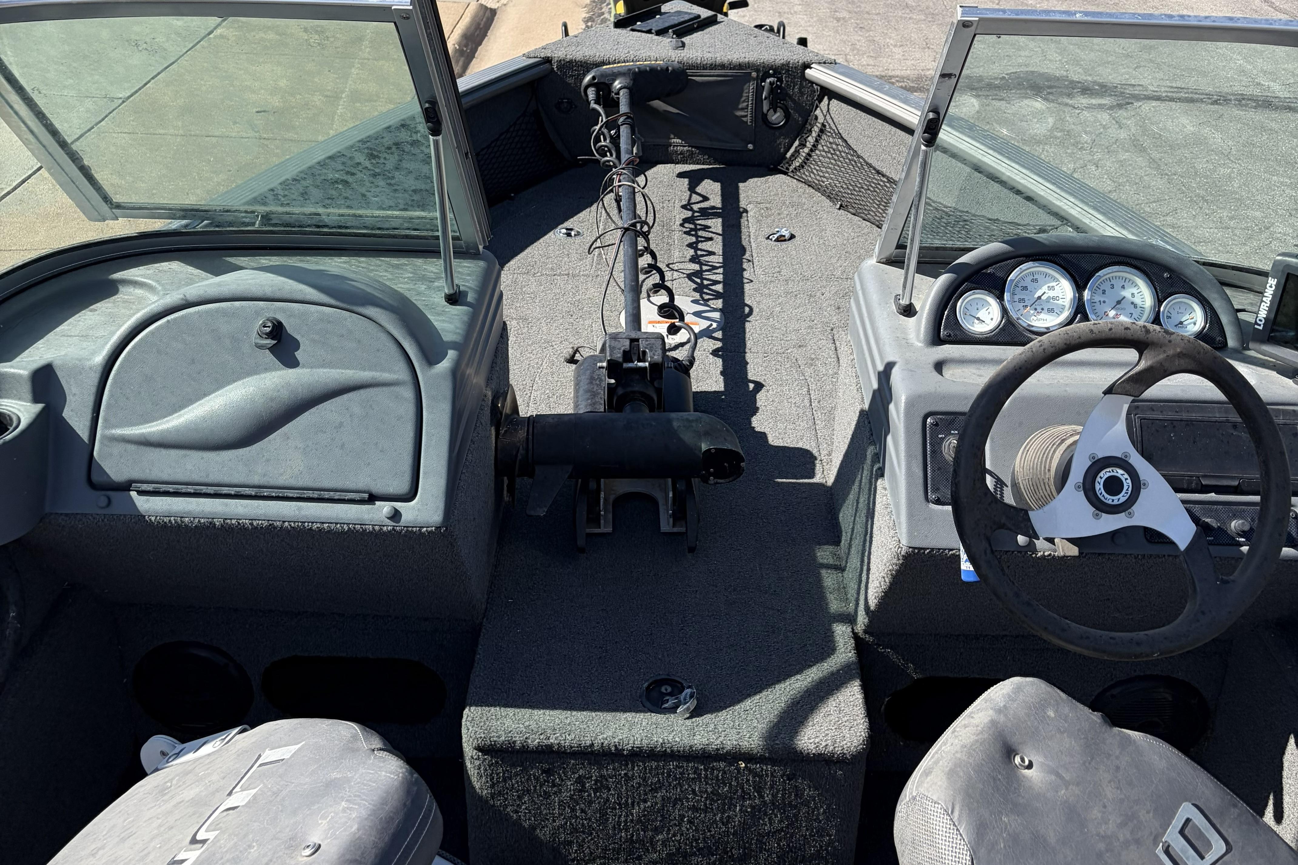 Interior view of a 2010 Lund 1825 Explorer boat, featuring steering wheel and dashboard.