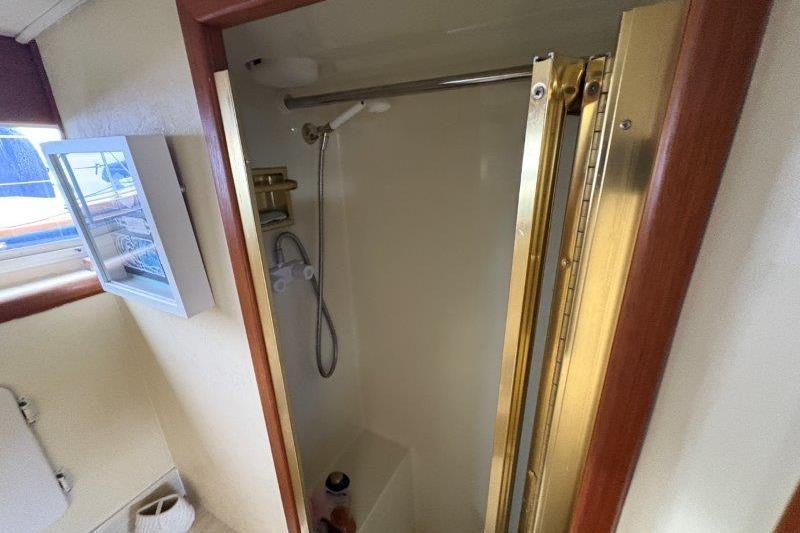 Shower area in 1987 Tollycraft 34 Sundeck Motor Yacht with gold trim.