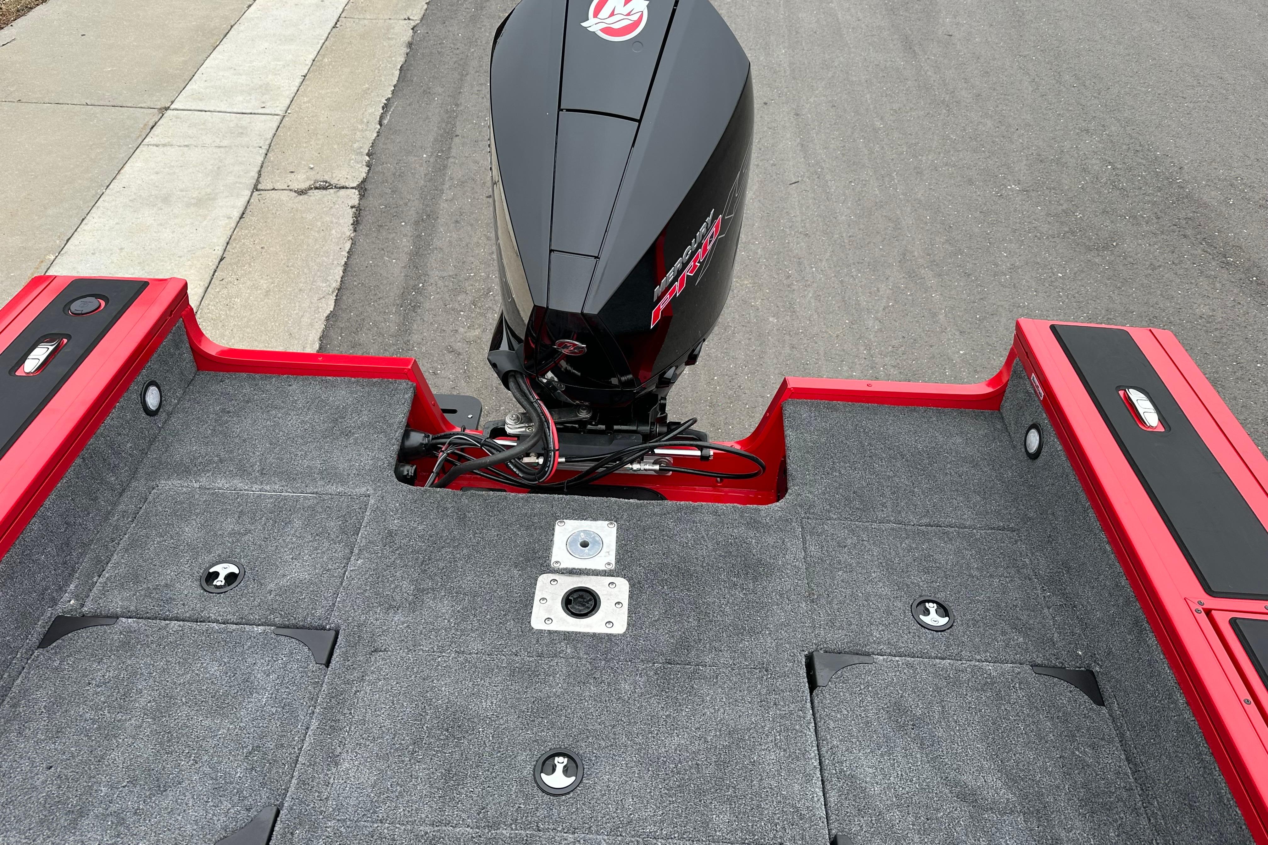 2026 Tracker Targa V-19 Combo boat with sleek black and red design, rear view.