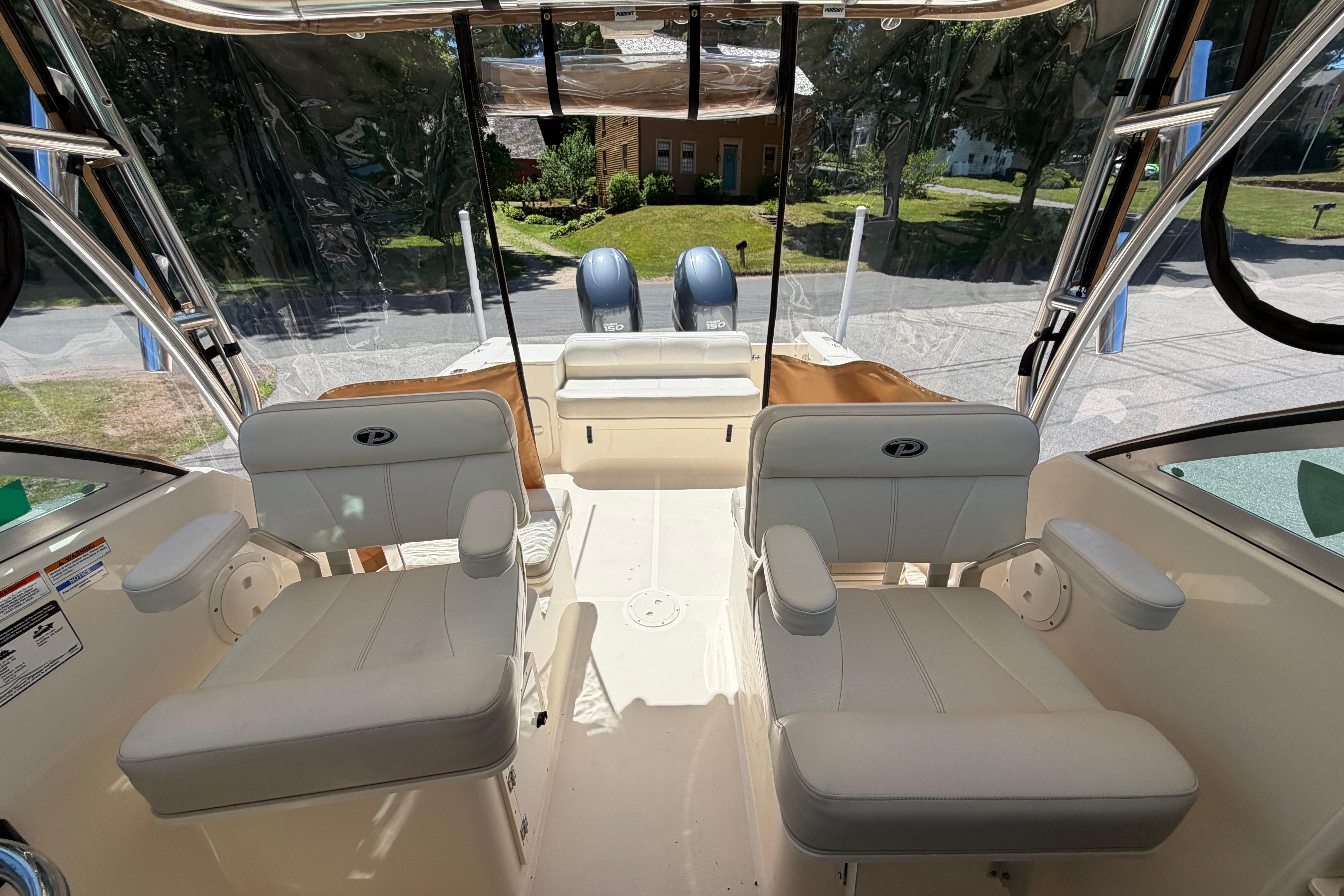 2010 Pursuit OS 255 Offshore boat interior with dual seats and clear canopy.