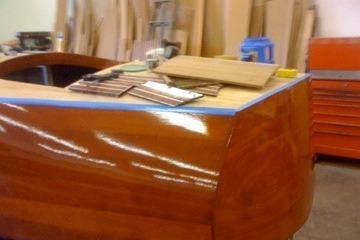 Restoration of 1931 Hacker-Craft 26 Dolphin boat with wooden finish in workshop.