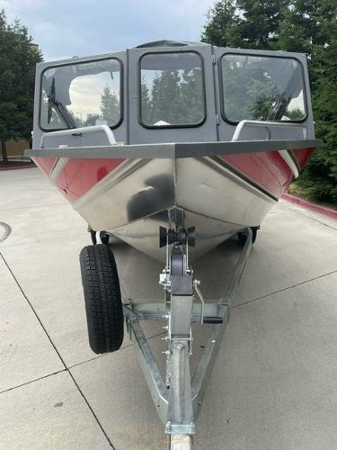 2025 Spartan 200 Astoria boat on trailer, front view, outdoors.