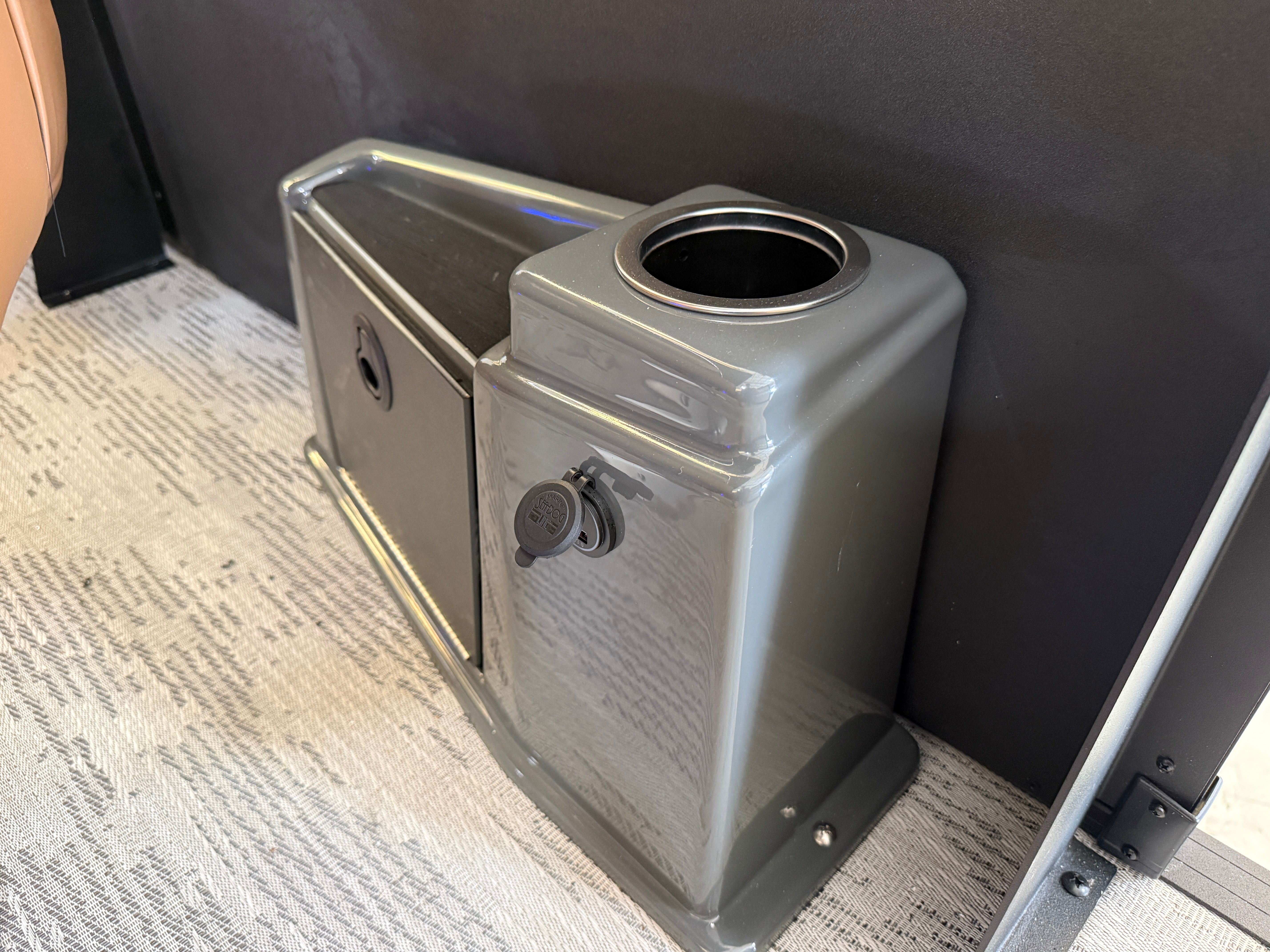 A modern cup holder and storage compartment in a Sylvan L3 ULZ DH boat.