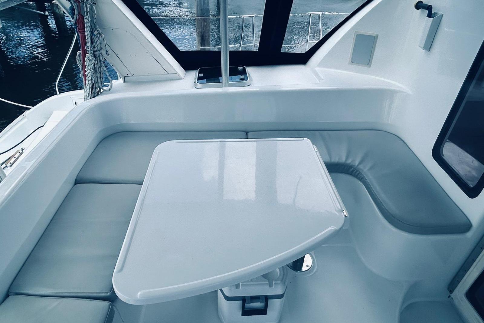 2001 Robertson & Caine Leopard yacht interior with sleek seating and table arrangement.