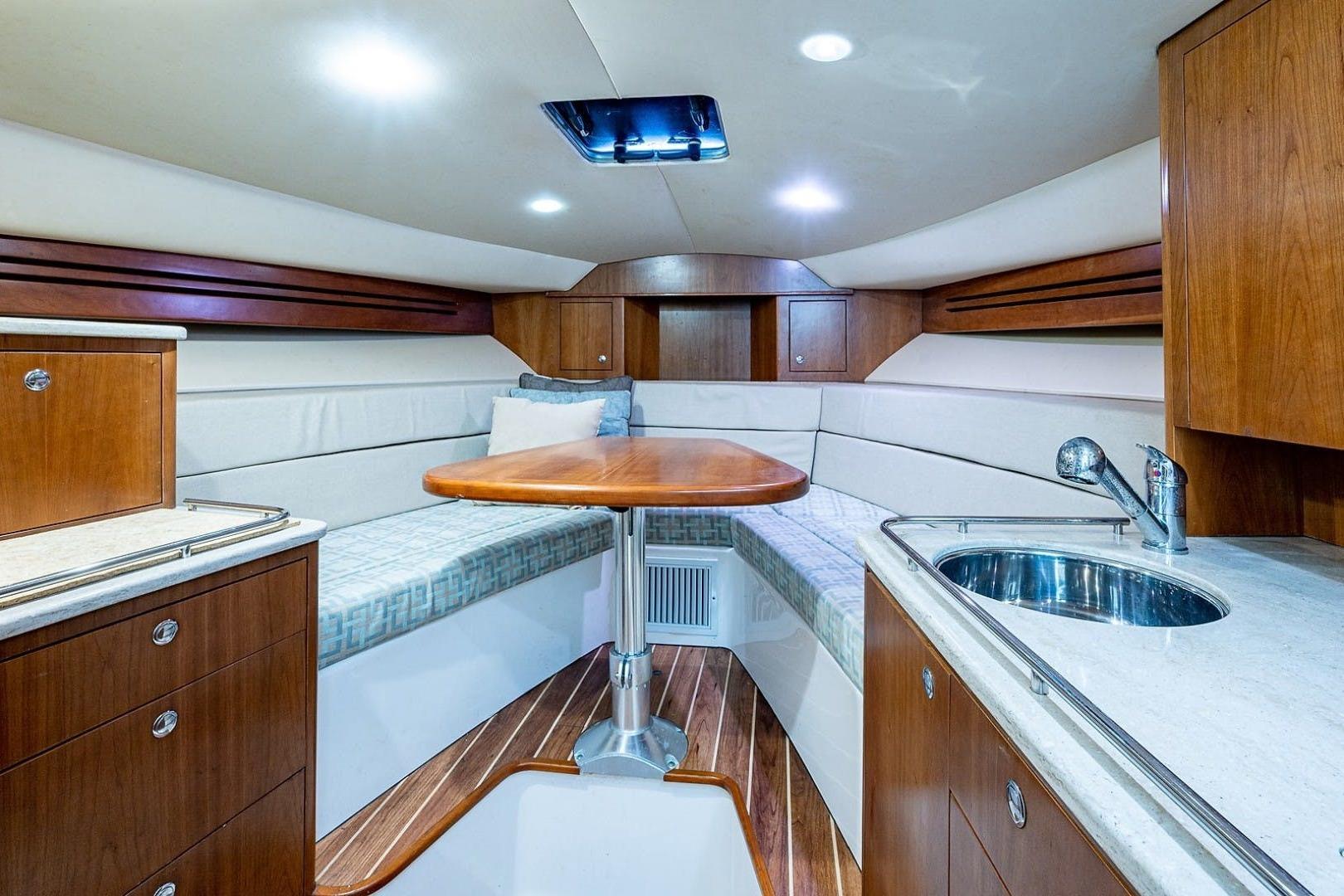 Luxurious interior of 2012 Brooks Boatworks 34, featuring wood cabinetry and modern amenities.