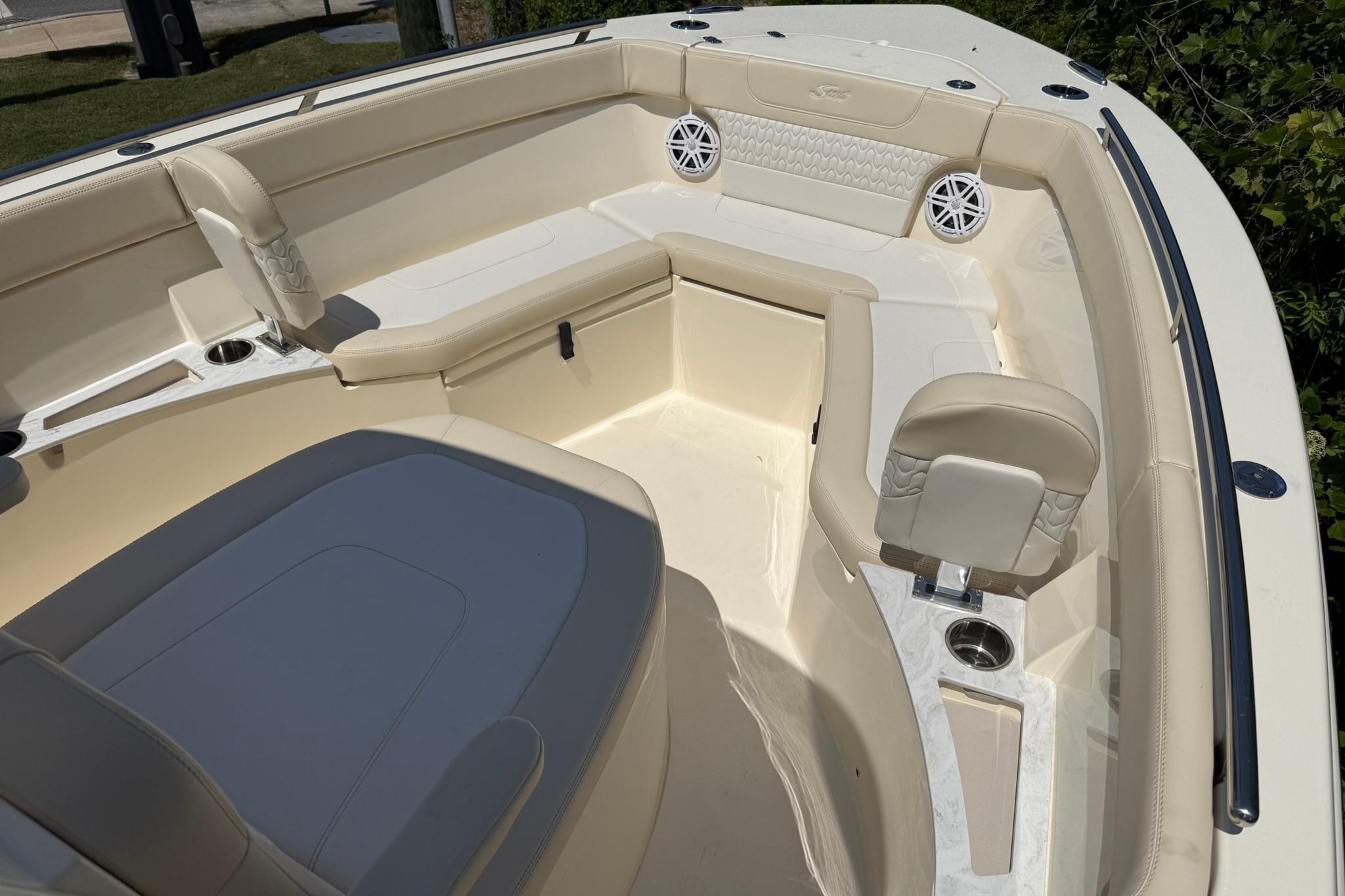 Luxurious interior of 2027 Scout 240 XSF boat with beige seating and cup holders.