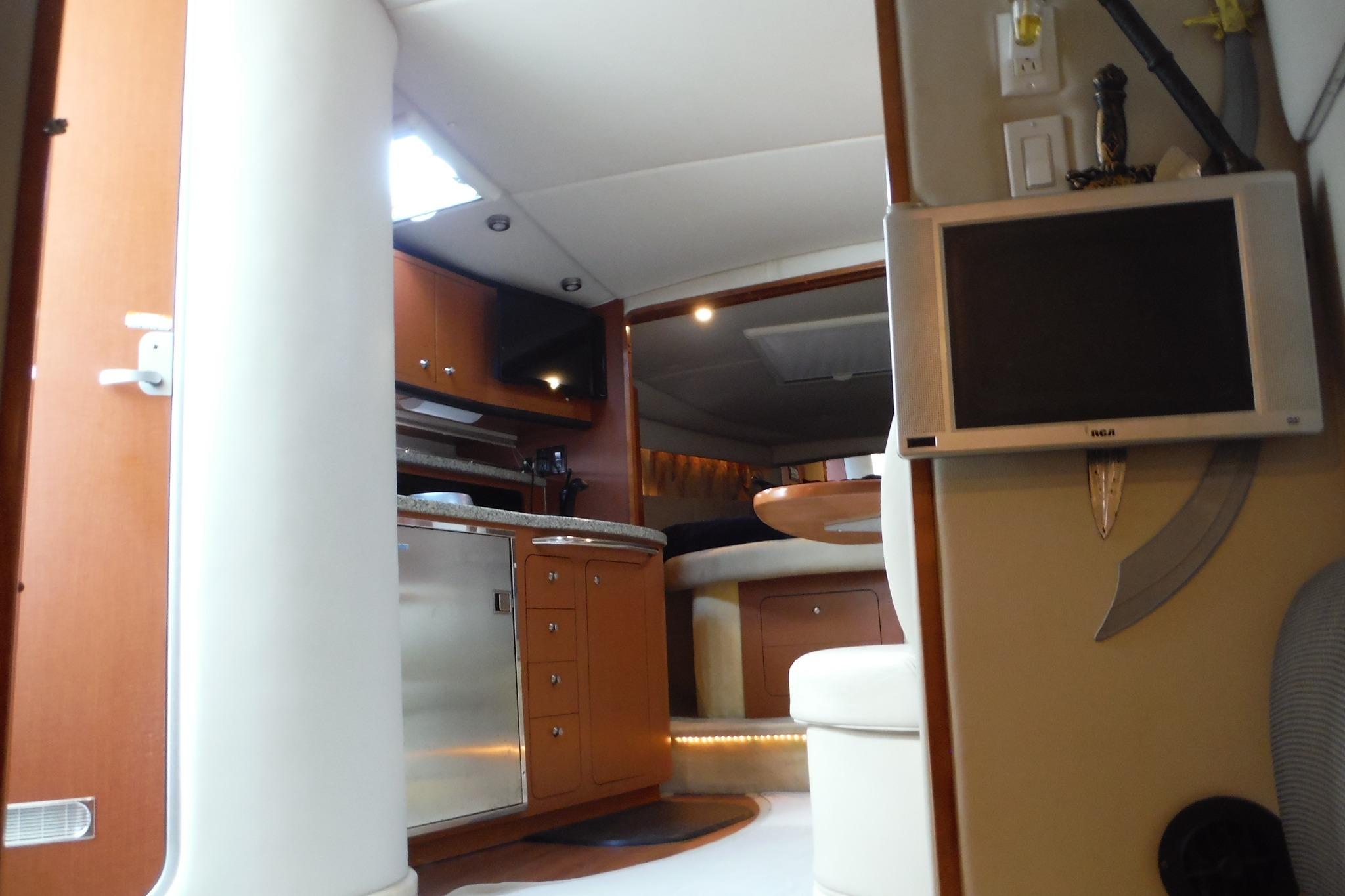 Interior of 2005 Chaparral Signature 350 yacht with modern amenities and wooden cabinetry.