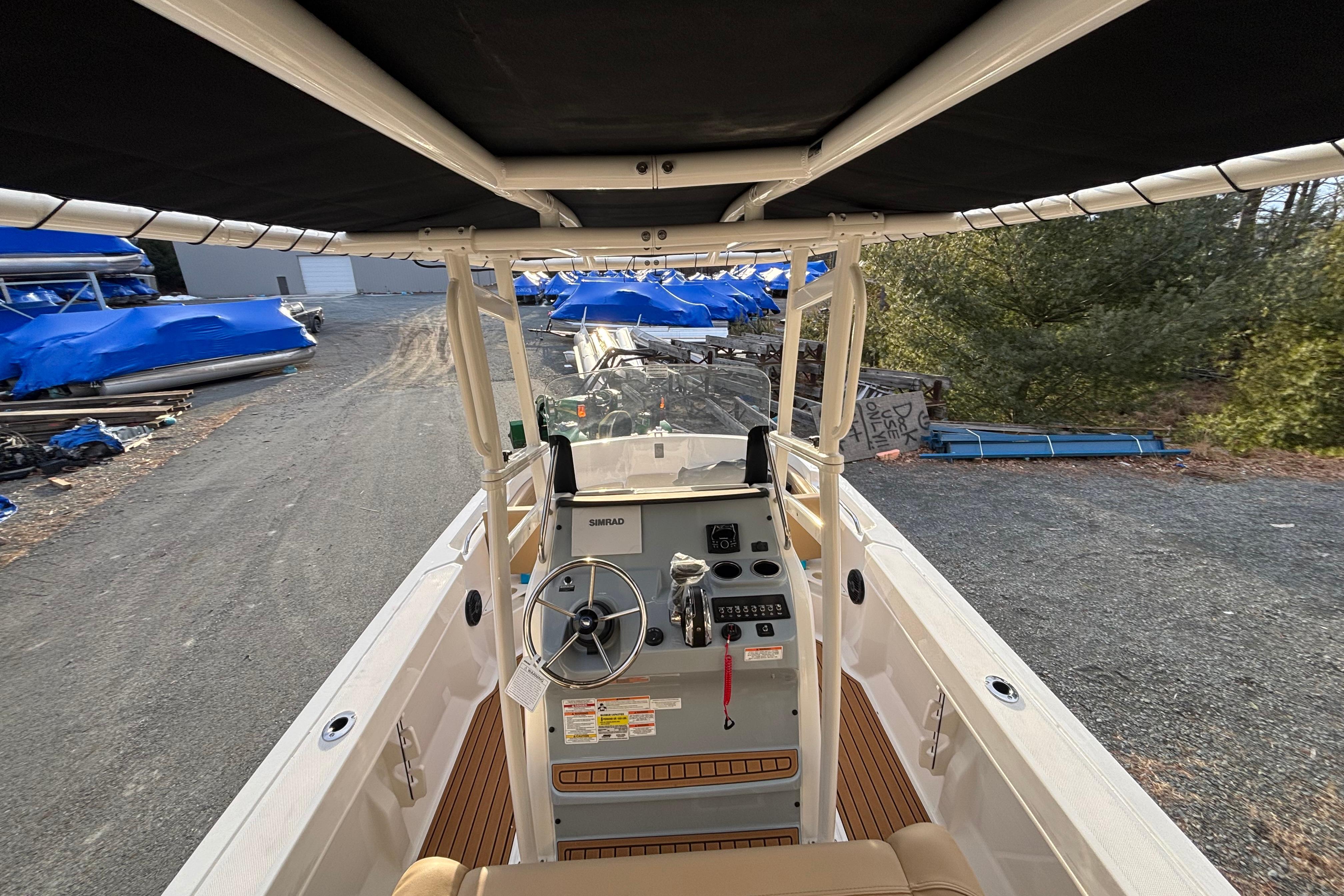 2026 Bayliner Trophy T20CC boat interior with steering console and canopy.