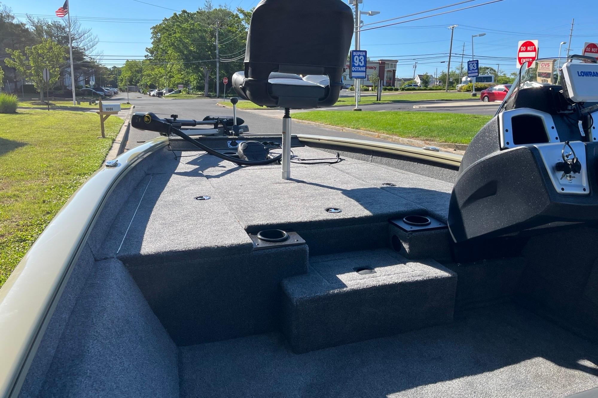 2026 Tracker Pro Team 175 boat interior with seating and control panel, parked outdoors.