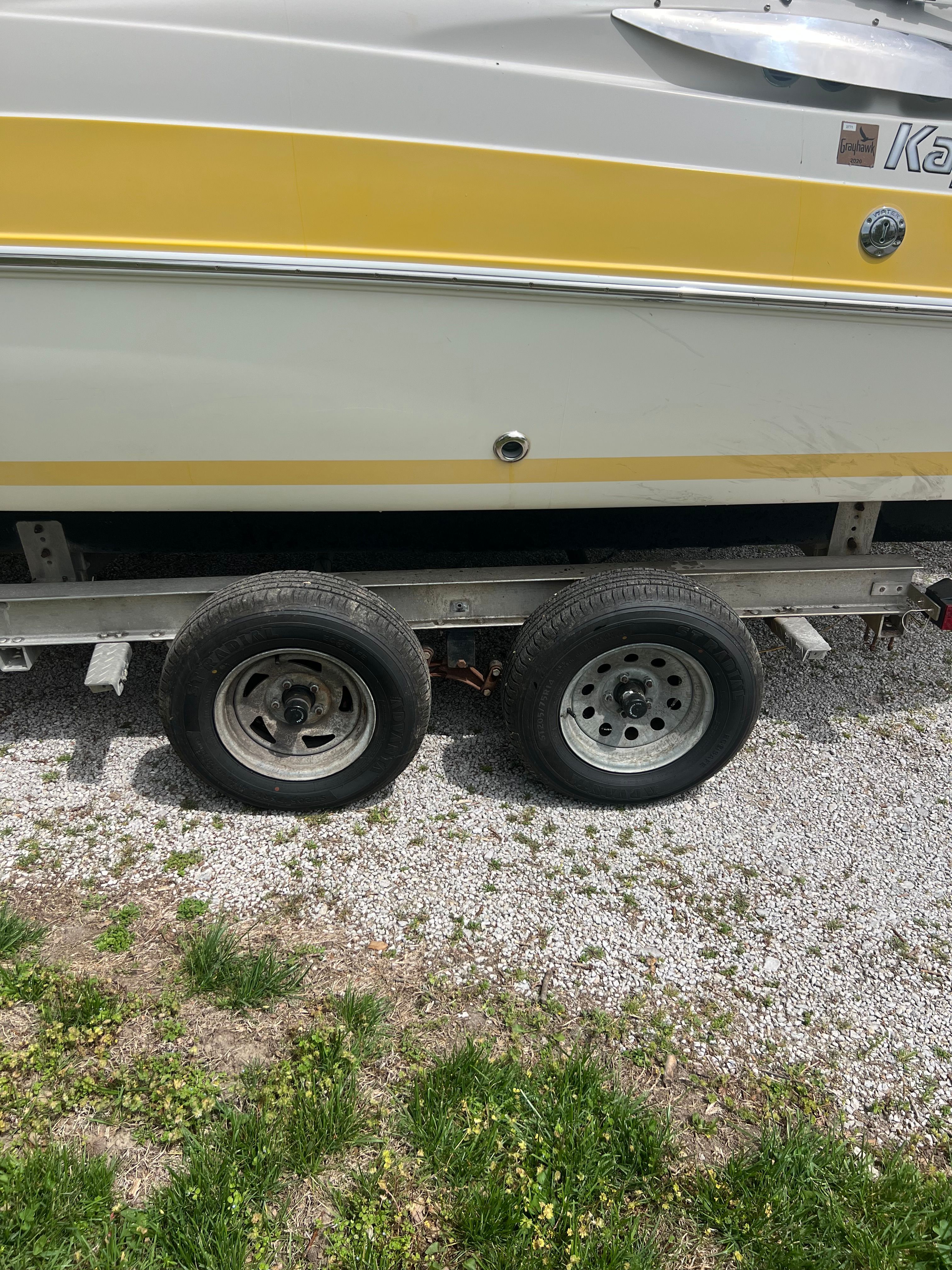 2007 Harris-Kayot S245 boat on trailer, yellow and white design.