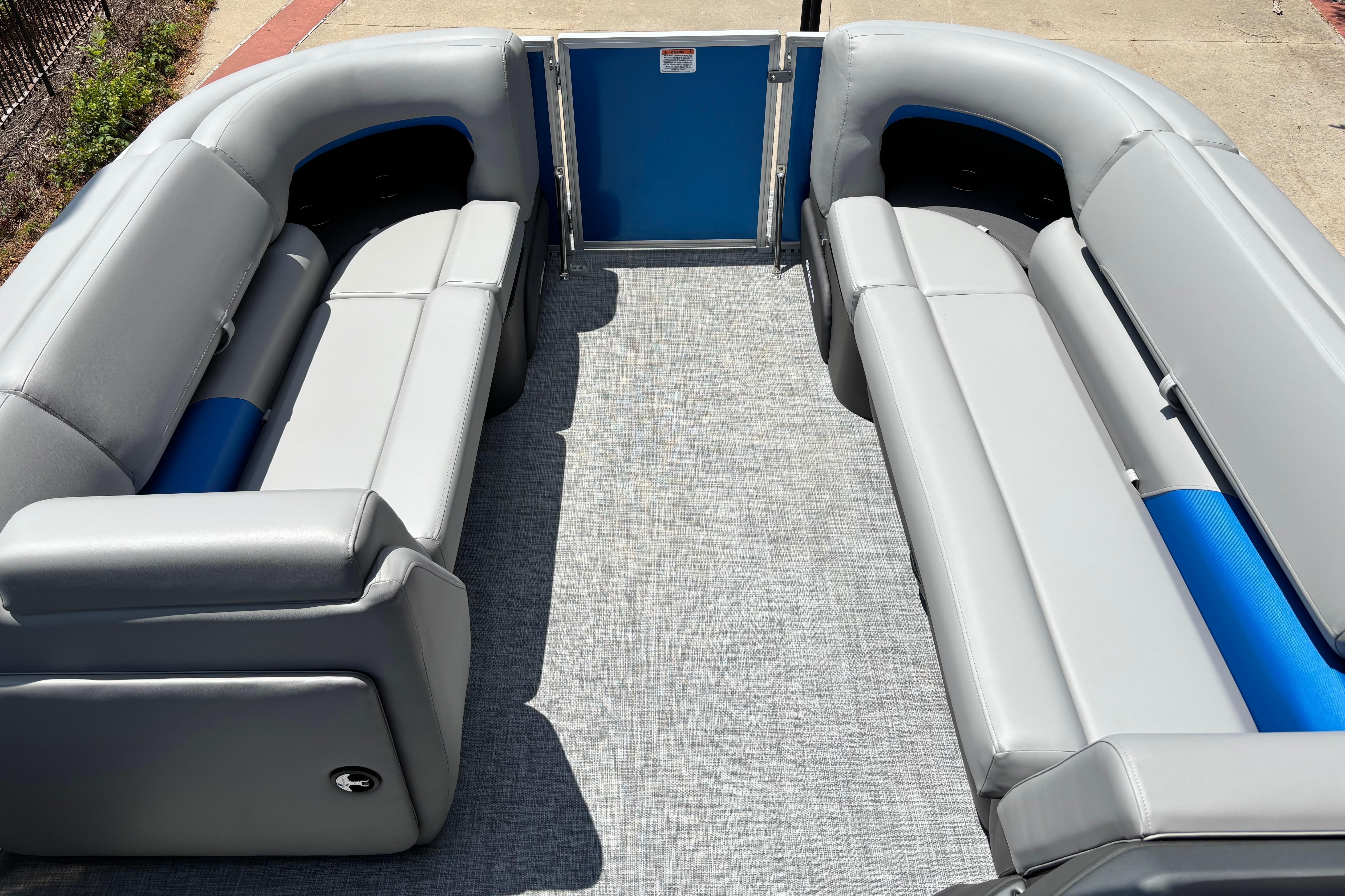 2026 Sun Tracker Party Barge 20 DLX with spacious gray seating and blue accents.