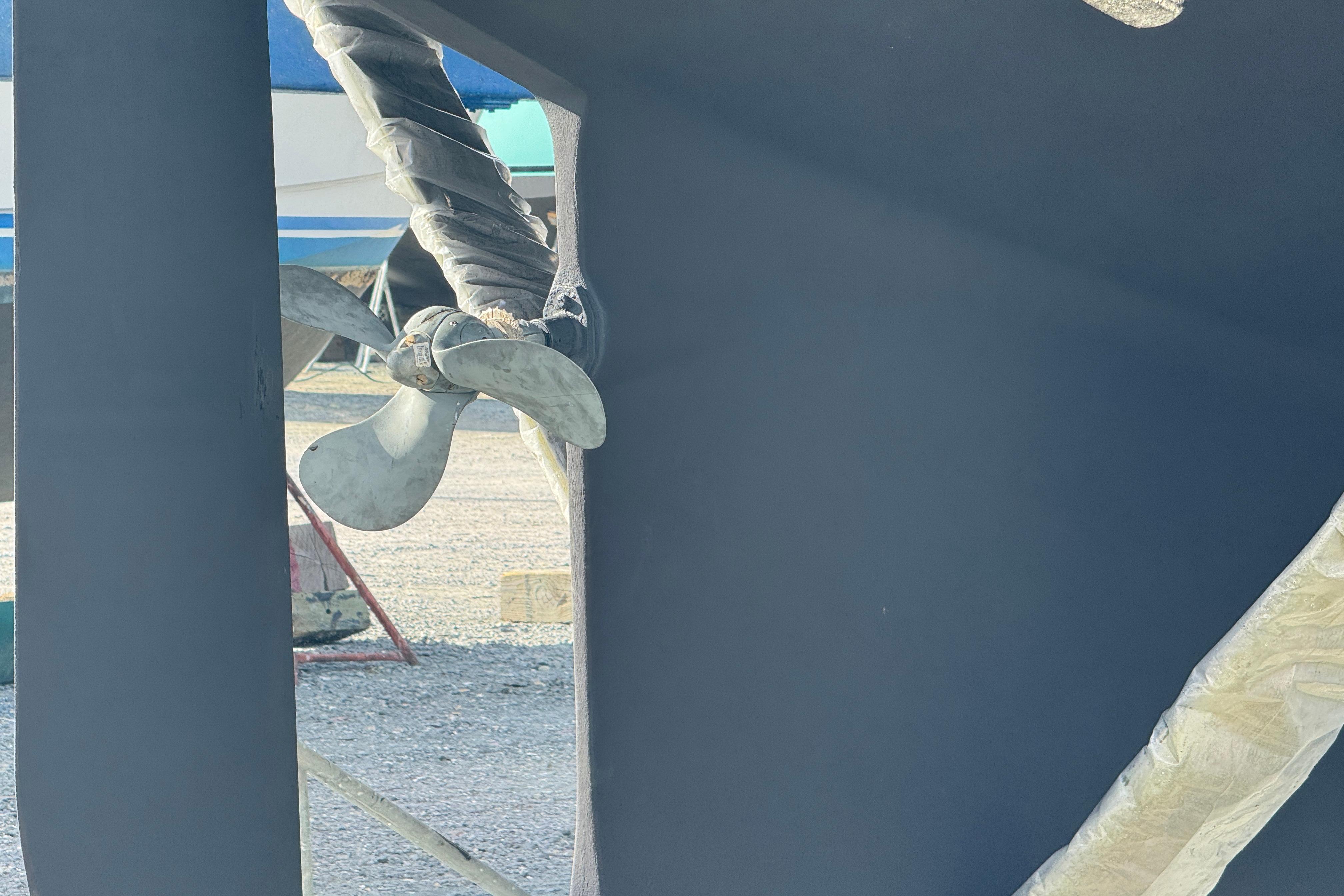 Propeller of 2000 Island Packet 380 sailboat in dry dock, wrapped for protection.