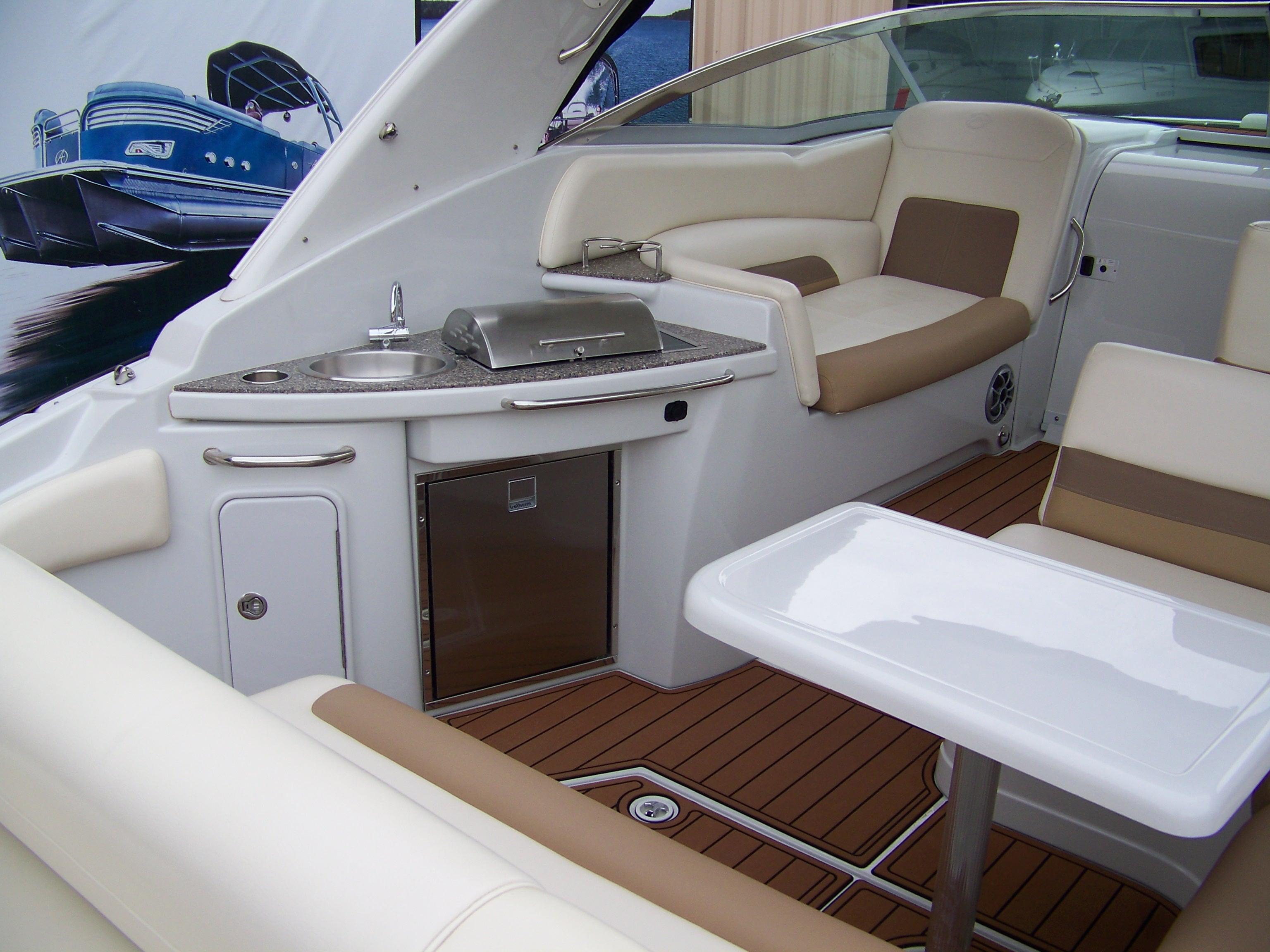 2020 Crownline 350 SY yacht interior with seating, table, and kitchenette.