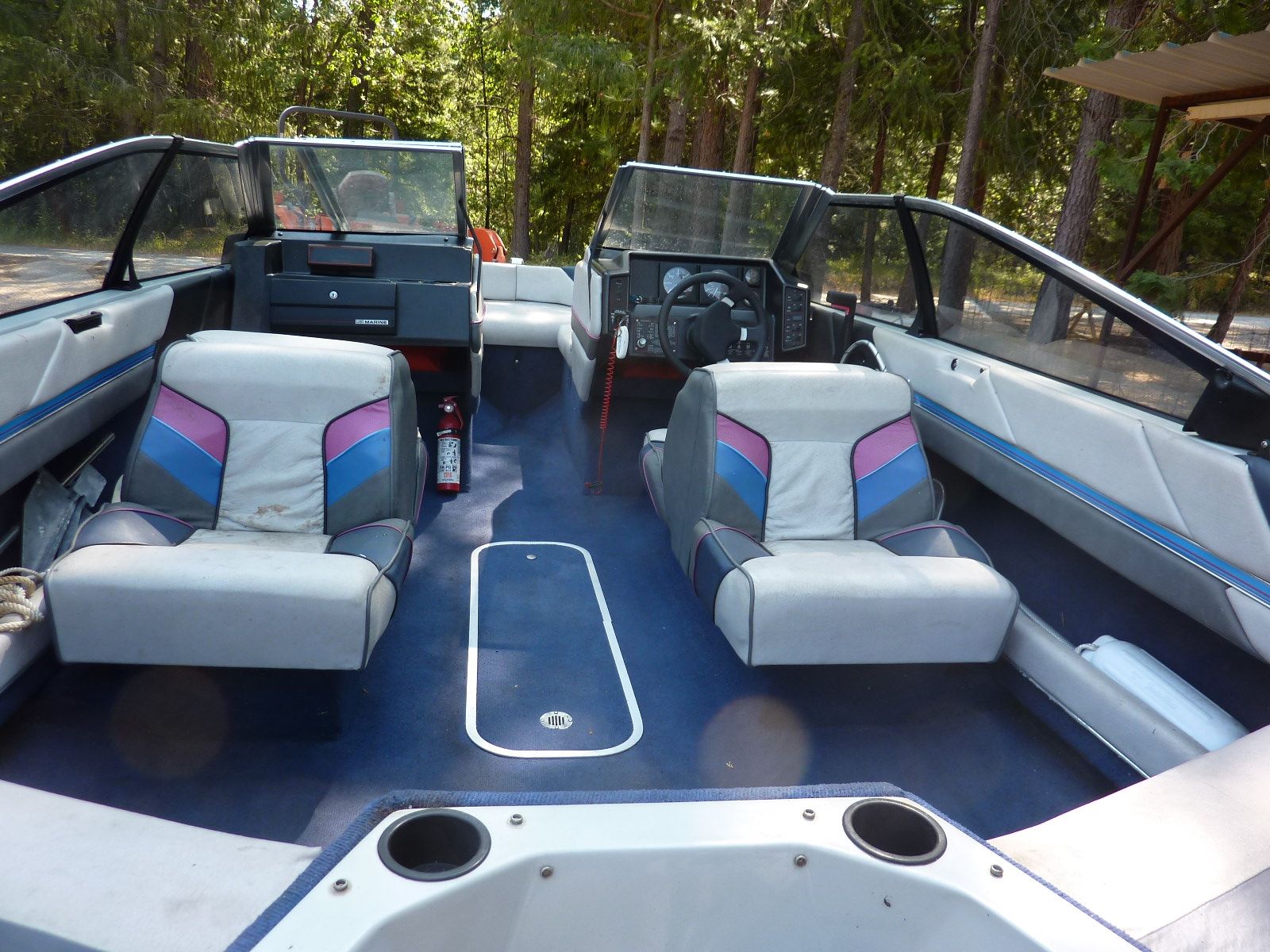 Interior view of a 1989 Bayliner CAPRI with two seats and a helm station.