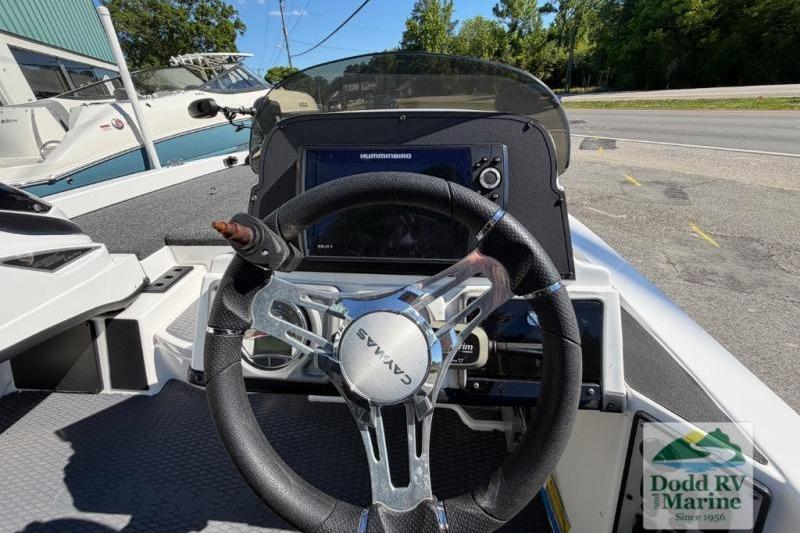 2021 Caymas CX 18 SS boat dashboard with steering wheel and navigation display.